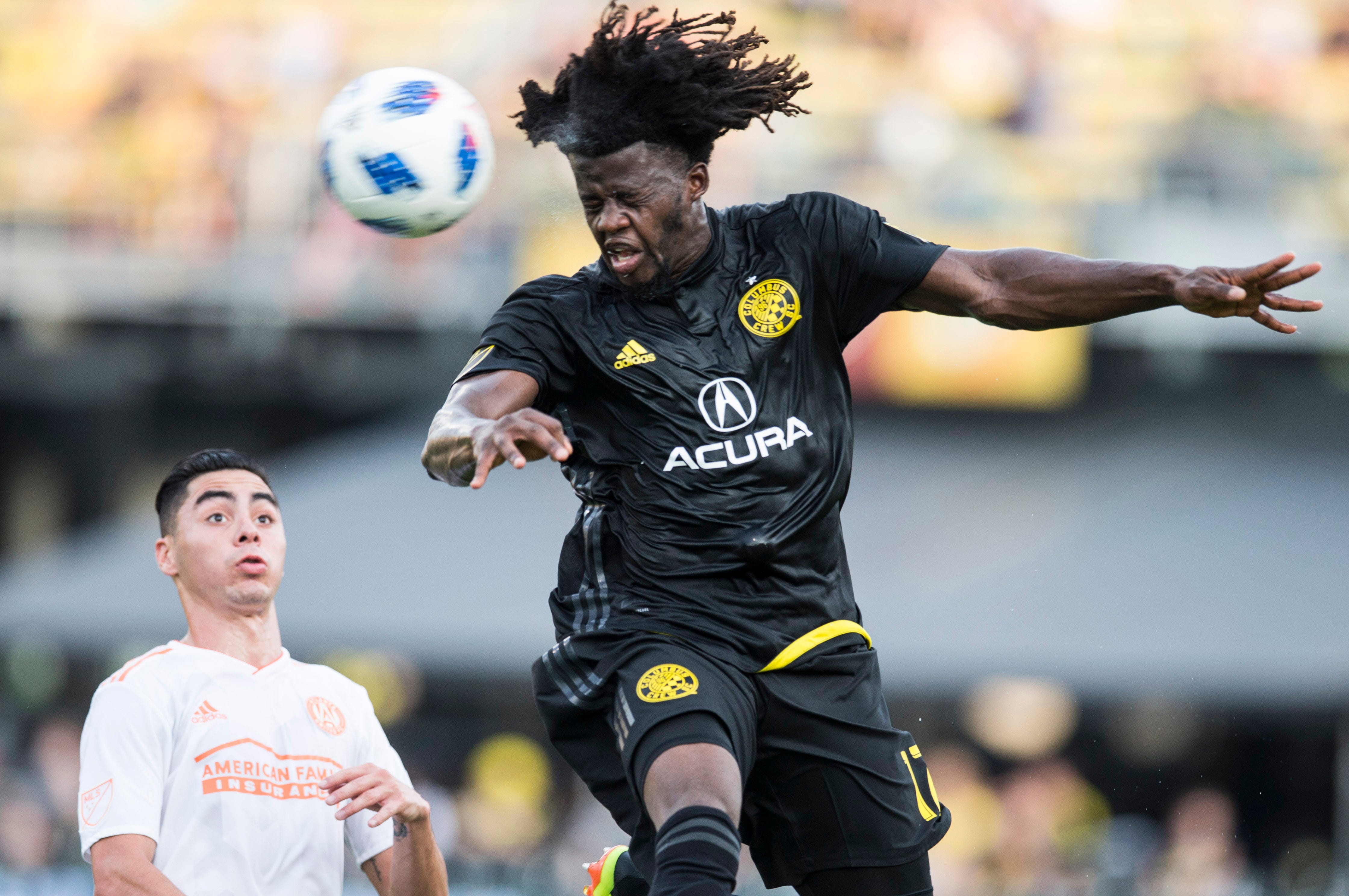 Columbus Crew SC defender Lalas Abubakar plays the ball out of the air in front of Atlanta United FC midfielder Miguel Almiron at MAPFRE Stadium in Columbus, Ohio.