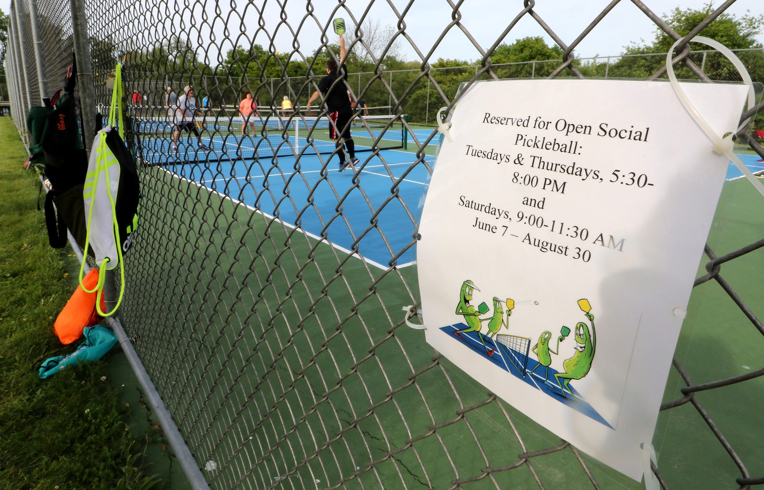 A sign on the fence reserves the court for Open Social Pickleball play at Franklin's Lion's Legend Park II on Drexel Road.