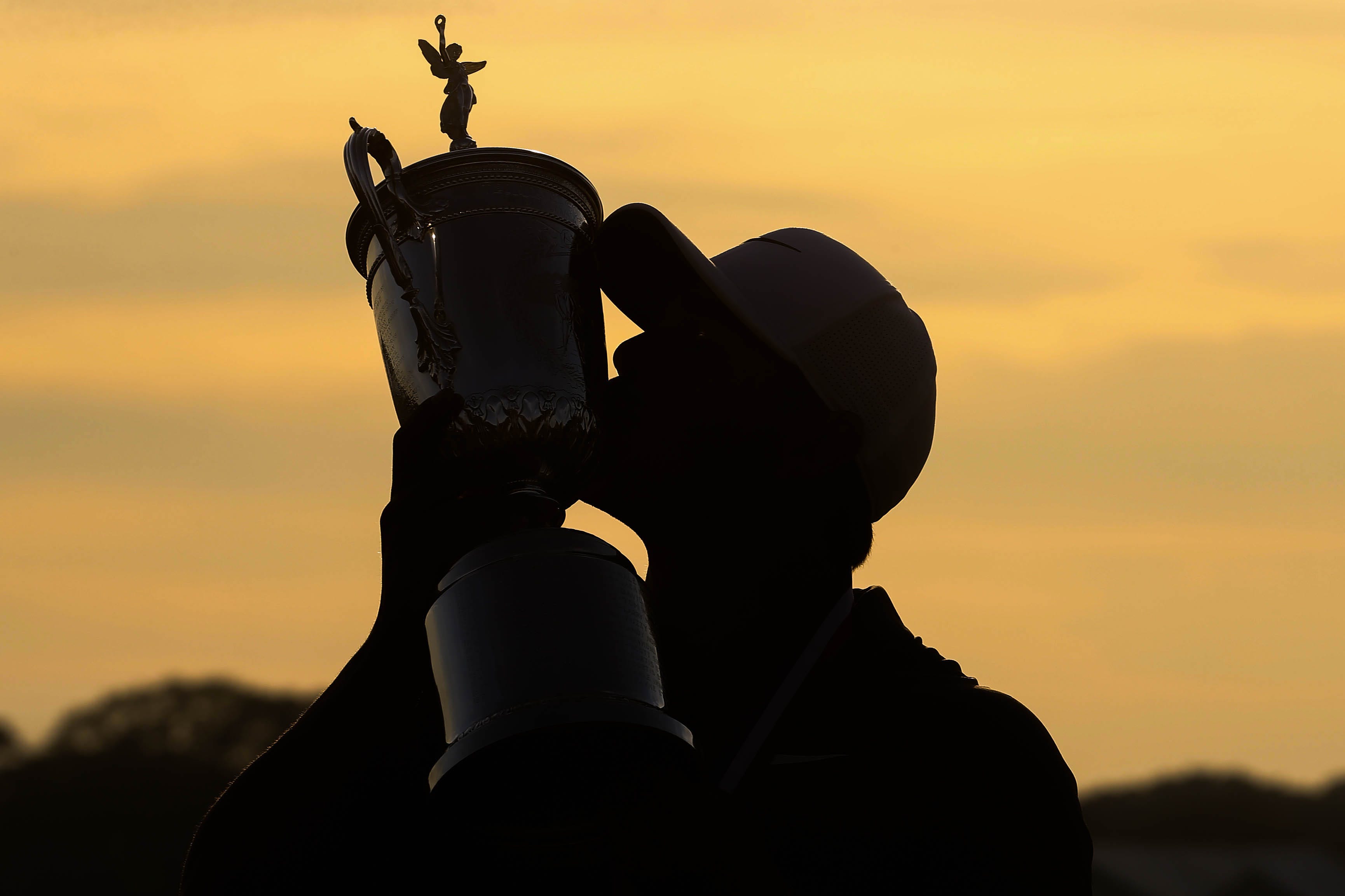 Brooks Koepka kisses the trophy after winning the U.S. Open golf tournament in Southampton, N.Y.