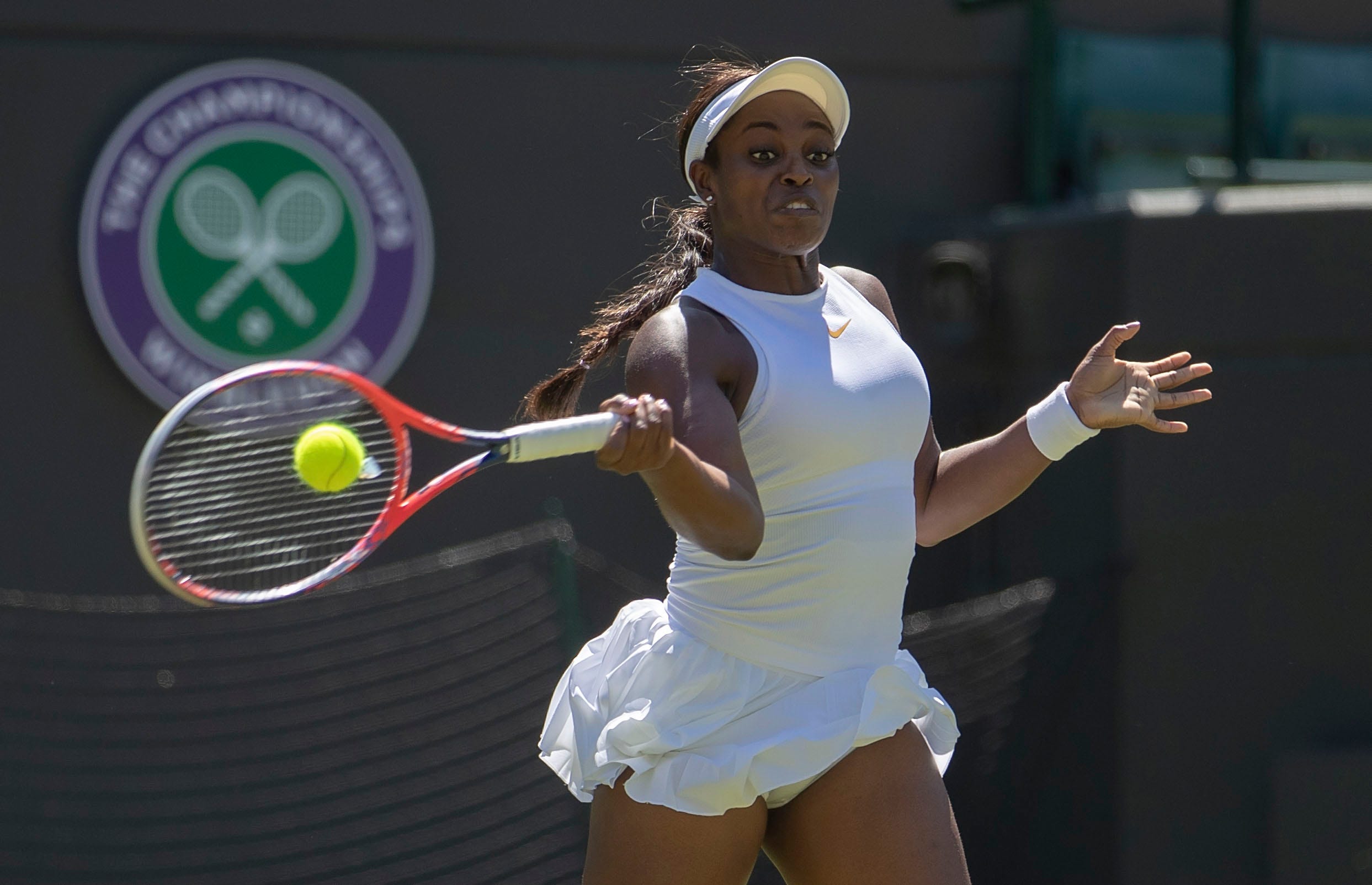 Sloane Stephens of the US hits a return  during her match against Donna Vekic of Croatia on day one at the All England Lawn and Croquet Club.