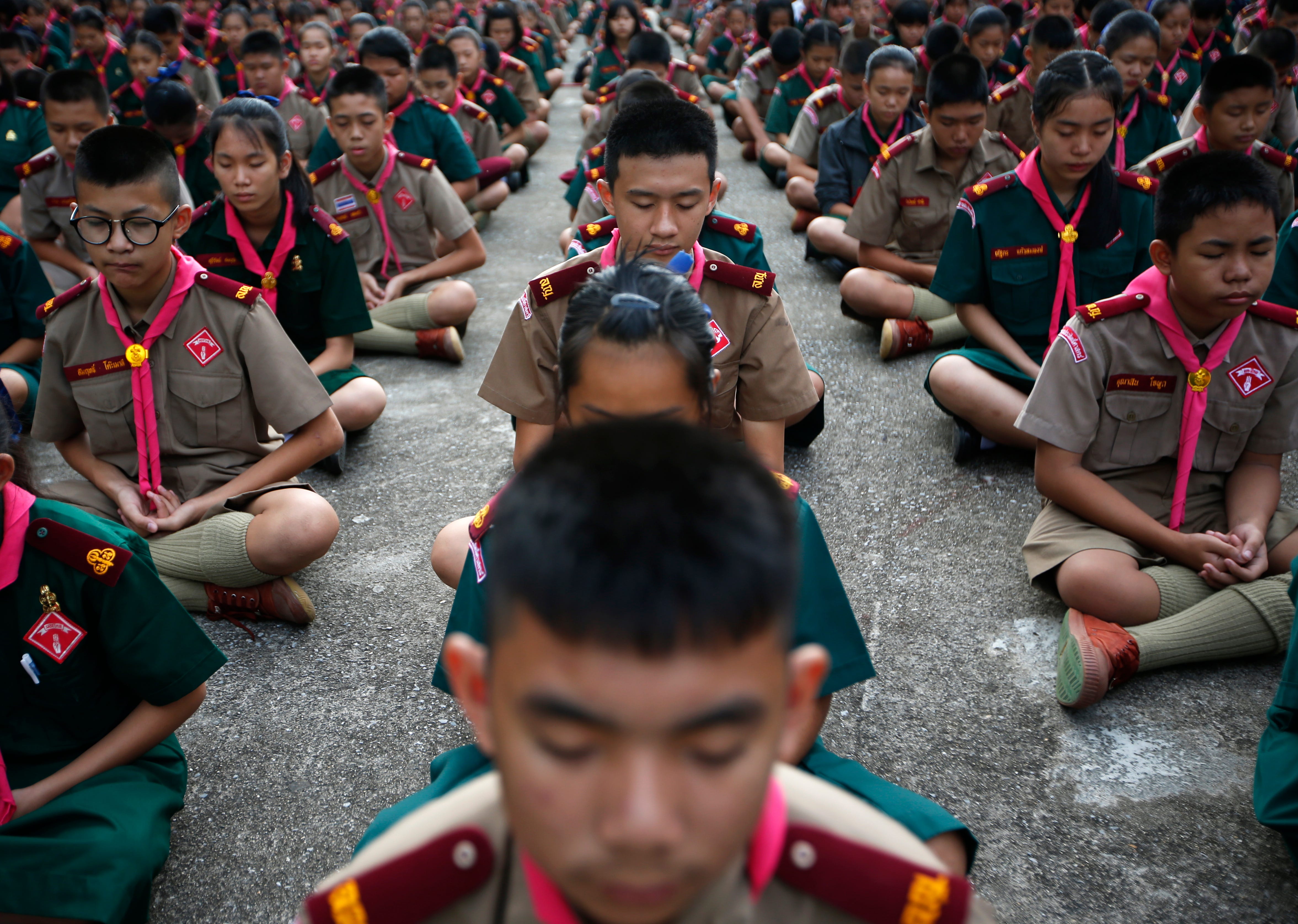  Thai students practice meditation in an effort to send regards to the ongoing rescue operations for the child soccer team and their assistant coach, at Maesaiprasitsart school in Mae Sai district, Chiang Rai province, Thailand.