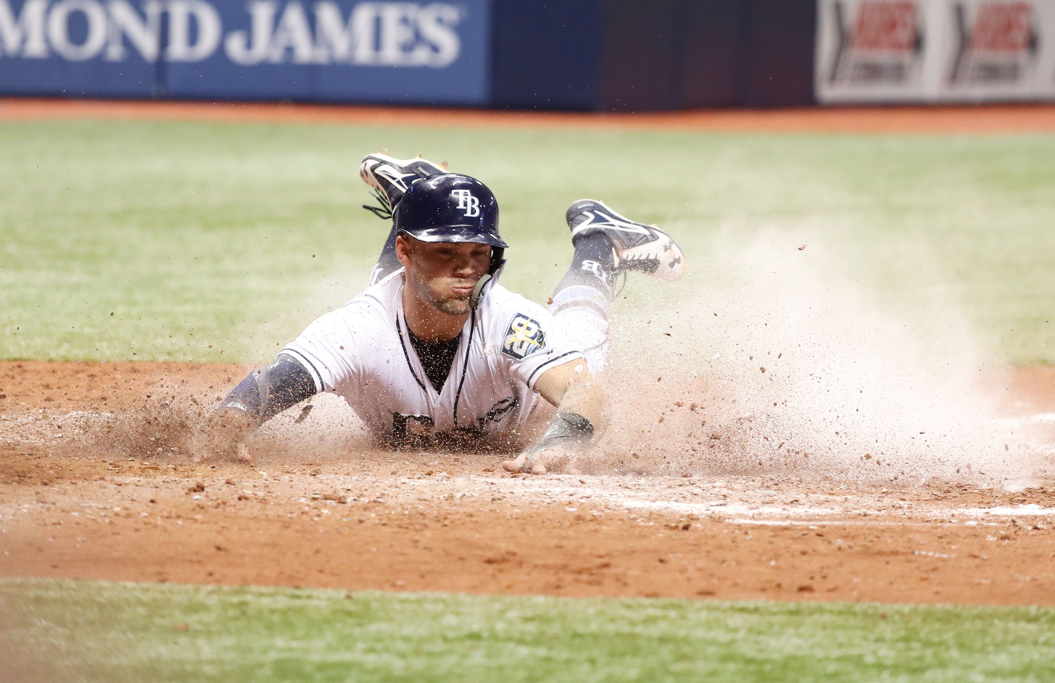 Tampa Bay Rays center fielder Johnny Field slides safe into home plate as he scores a run during the seventh inning against the Detroit Tigers  at Tropicana Field.