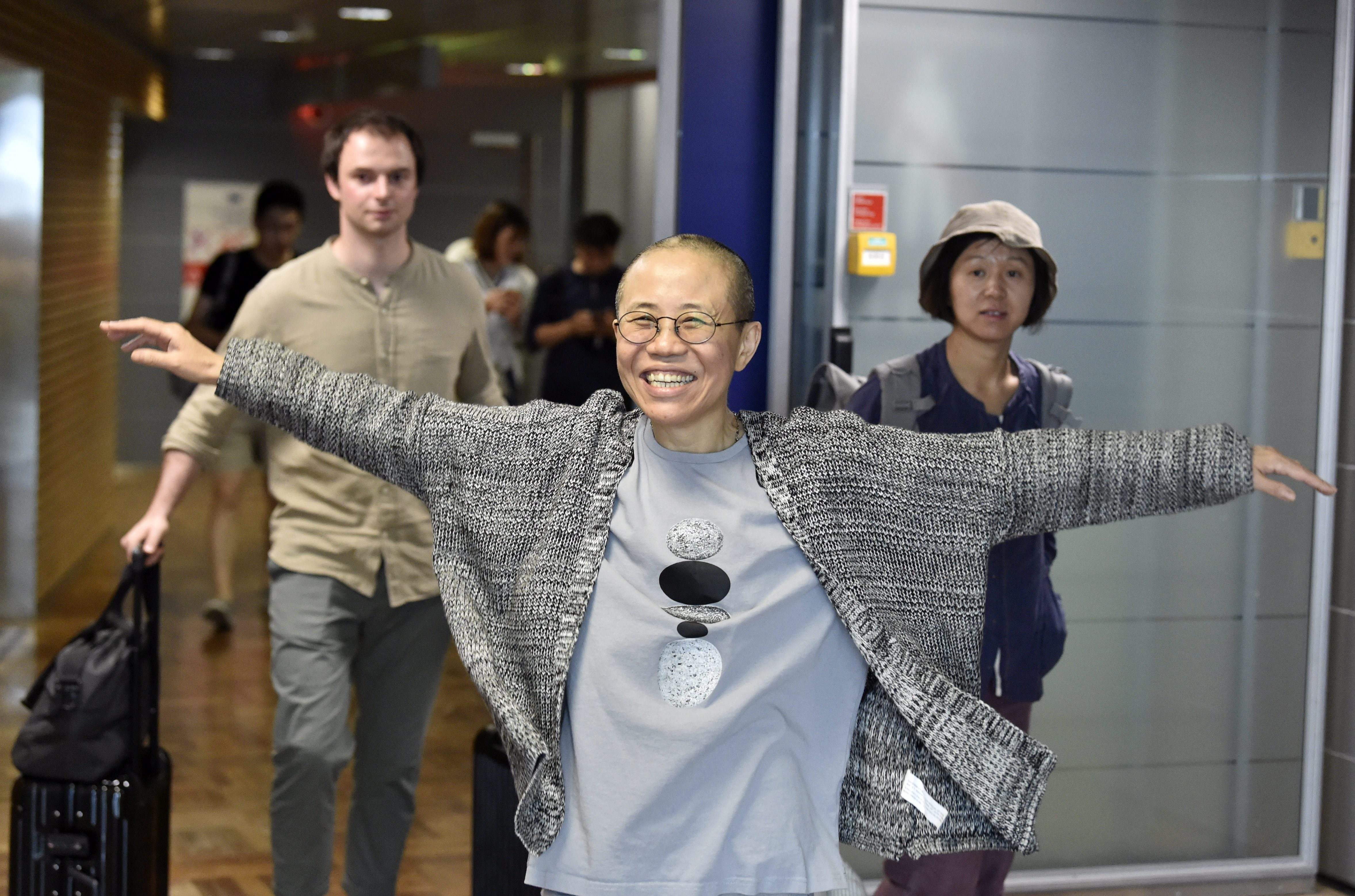 Liu Xia, the widow of Chinese Nobel dissident Liu Xiaobo, smiles as she arrives at the Helsinki International Airport in Vantaa, Finland. Despite facing no charges, the 57-year-old poet had endured heavy restrictions on her movements since 2010 when 
