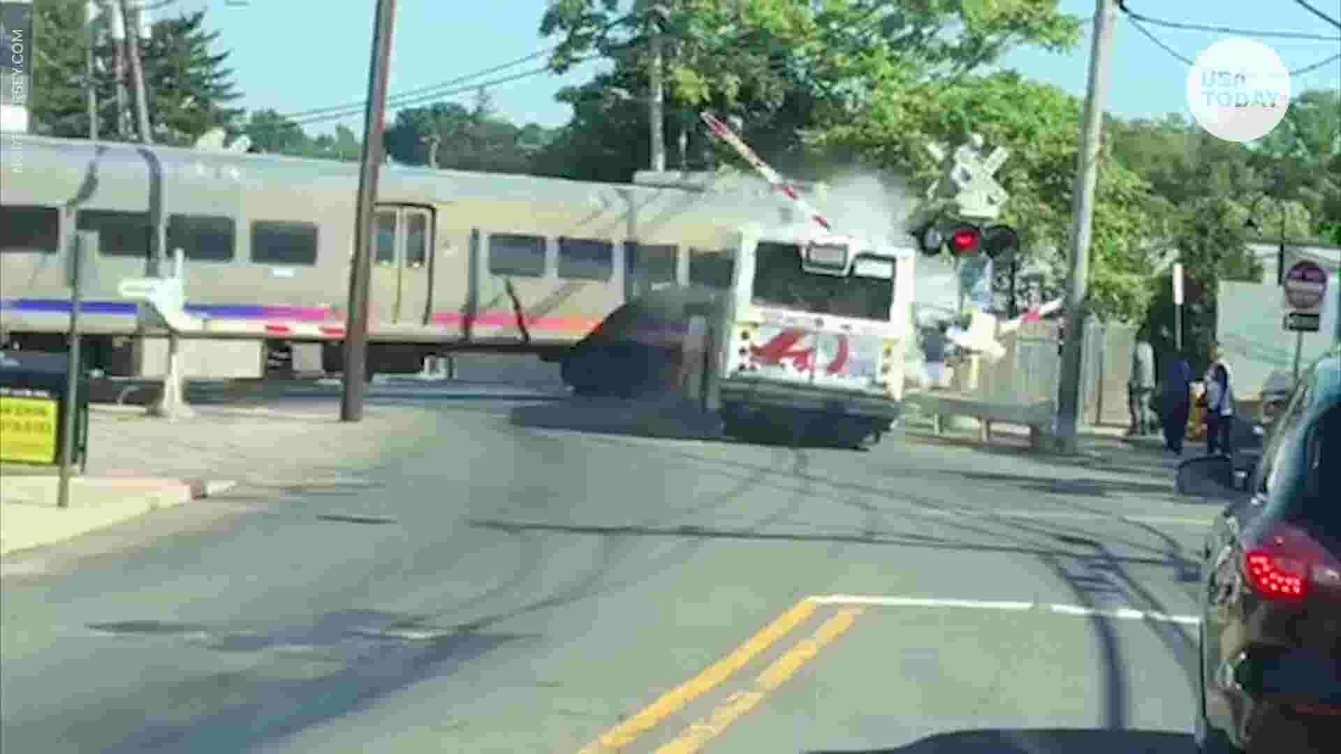 Train slams into bus in middle of tracks