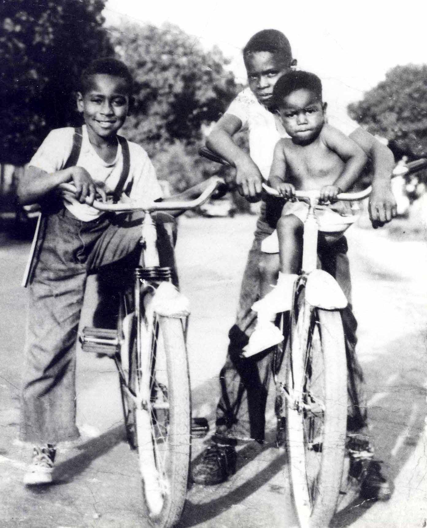 In this circa 1950 photograph taken in Argo-Summit, Ill., Emmett Till (left) sits on a bicycle beside his cousin, Wheeler Parker (right) with his passenger, Joe Williams.