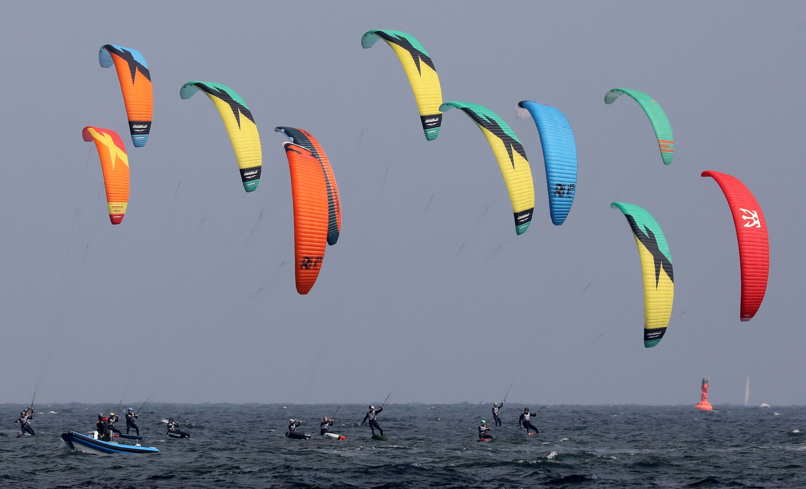 Kite surfers take the start of a race at the European Championships off the coast of Warnemuende, on the Baltic Sea in northern Germany.