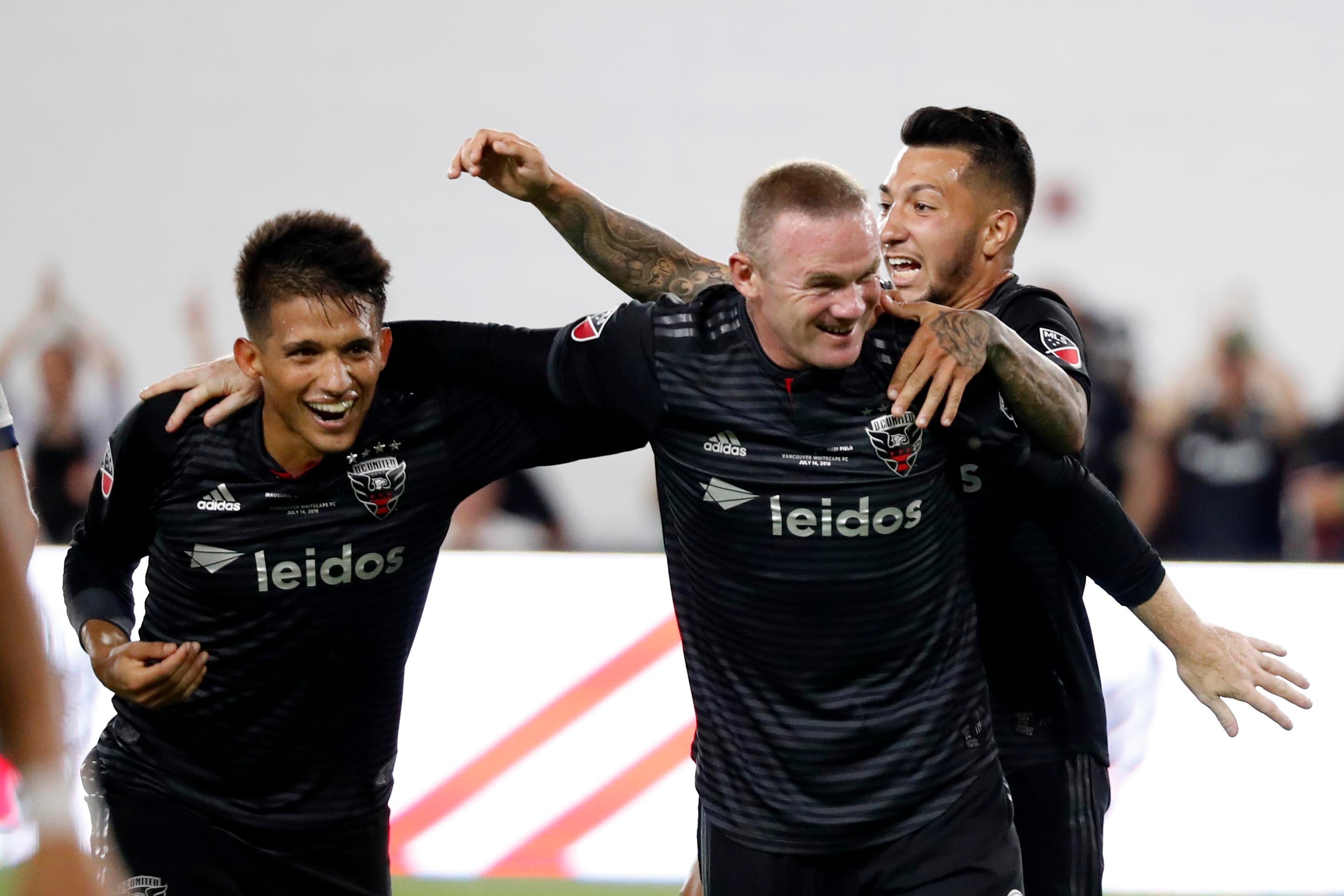 Wayne Rooney (right) celebrates a D.C. United goal with teammates during the inaugural game at Audi Field. D.C. United won the game, 3-1.