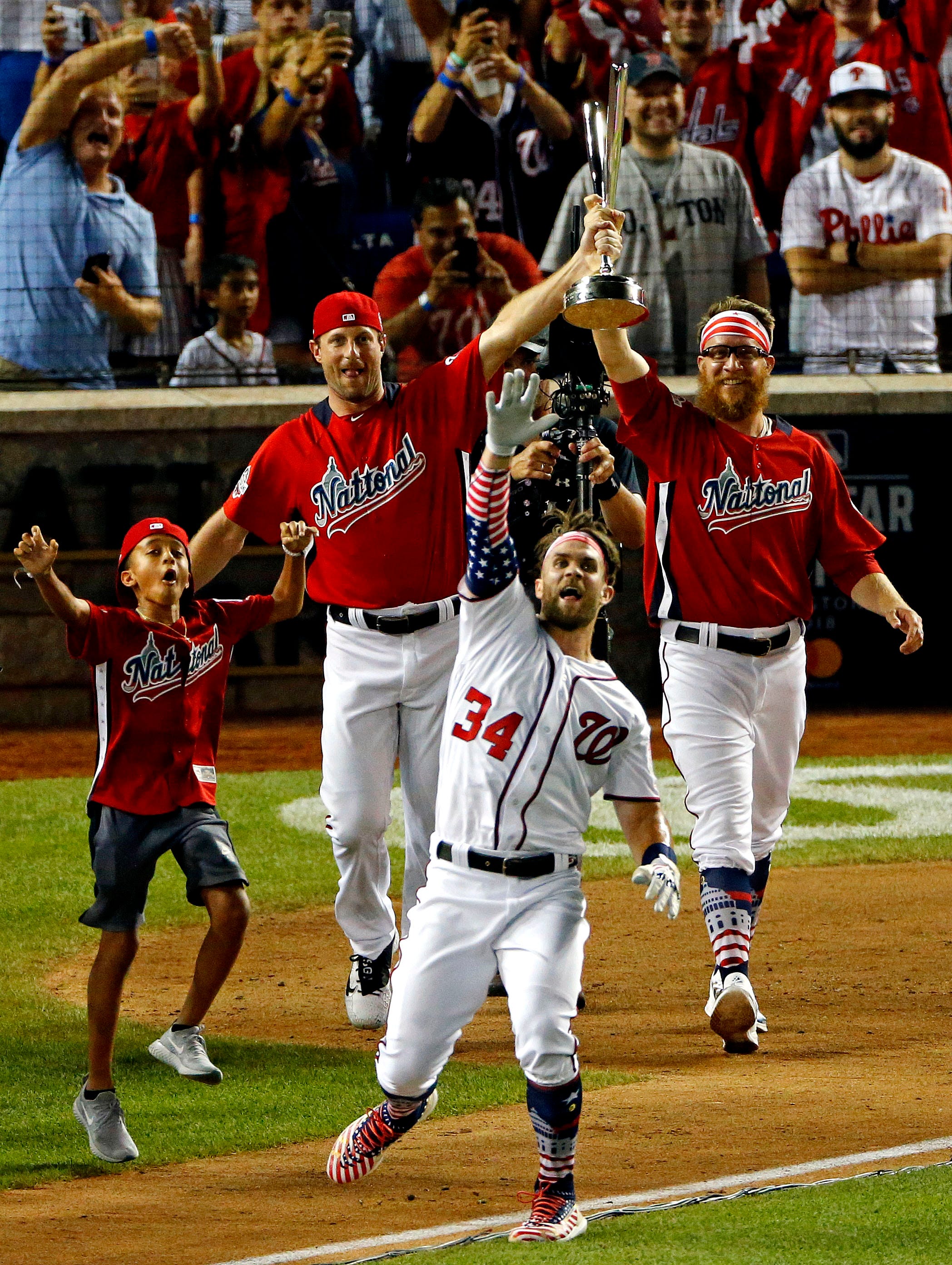 Washington Nationals right fielder Bryce Harper celebrates winning the 2018 MLB home run derby at Nationals Ballpark in Washington.