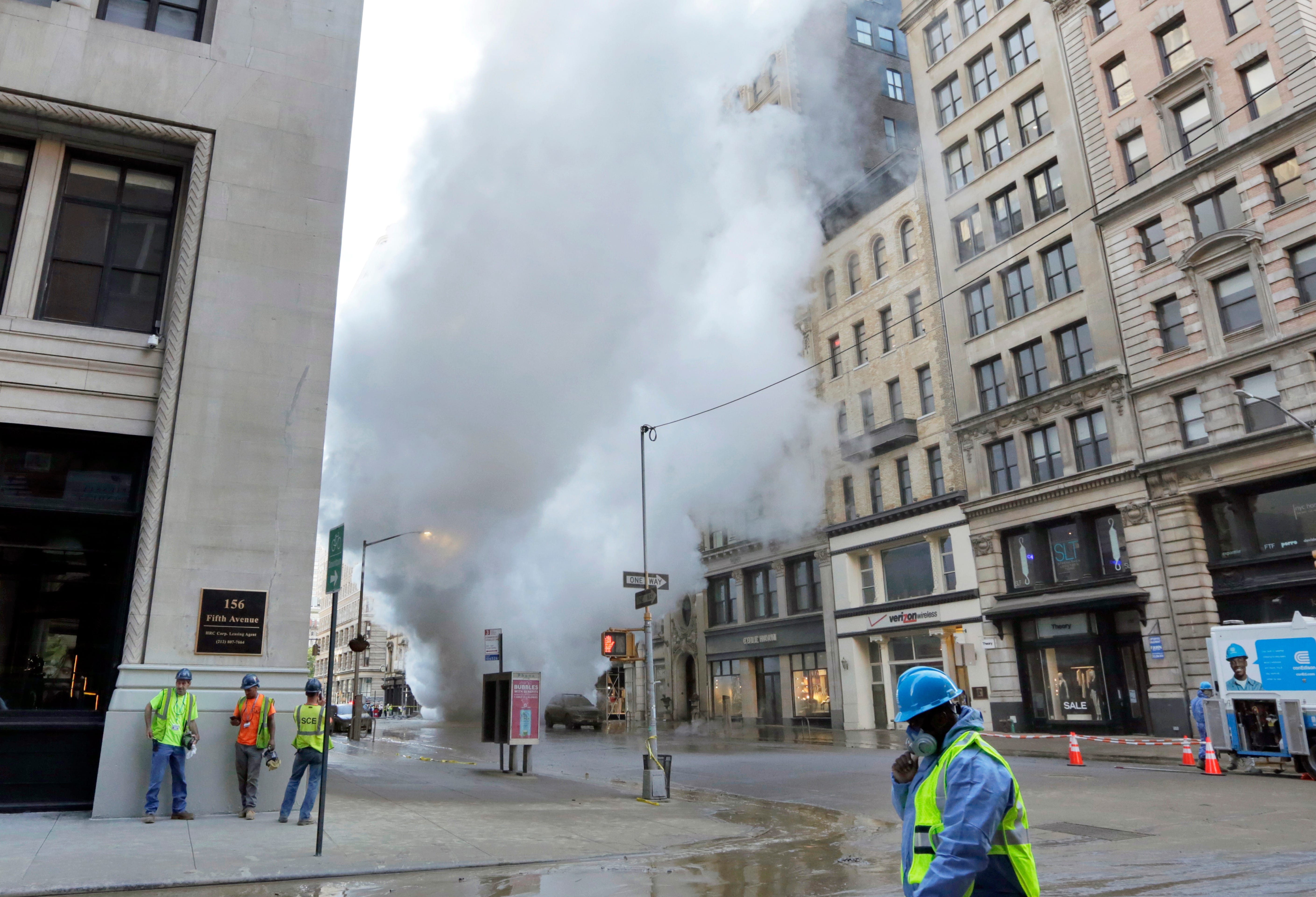Steam billows on New York's Fifth Avenue, July 19, 2018. A steam pipe exploded beneath Fifth Avenue in Manhattan early Thursday, sending chunks of asphalt flying, a geyser of billowing white steam stories into the air and forcing pedestrians to take 