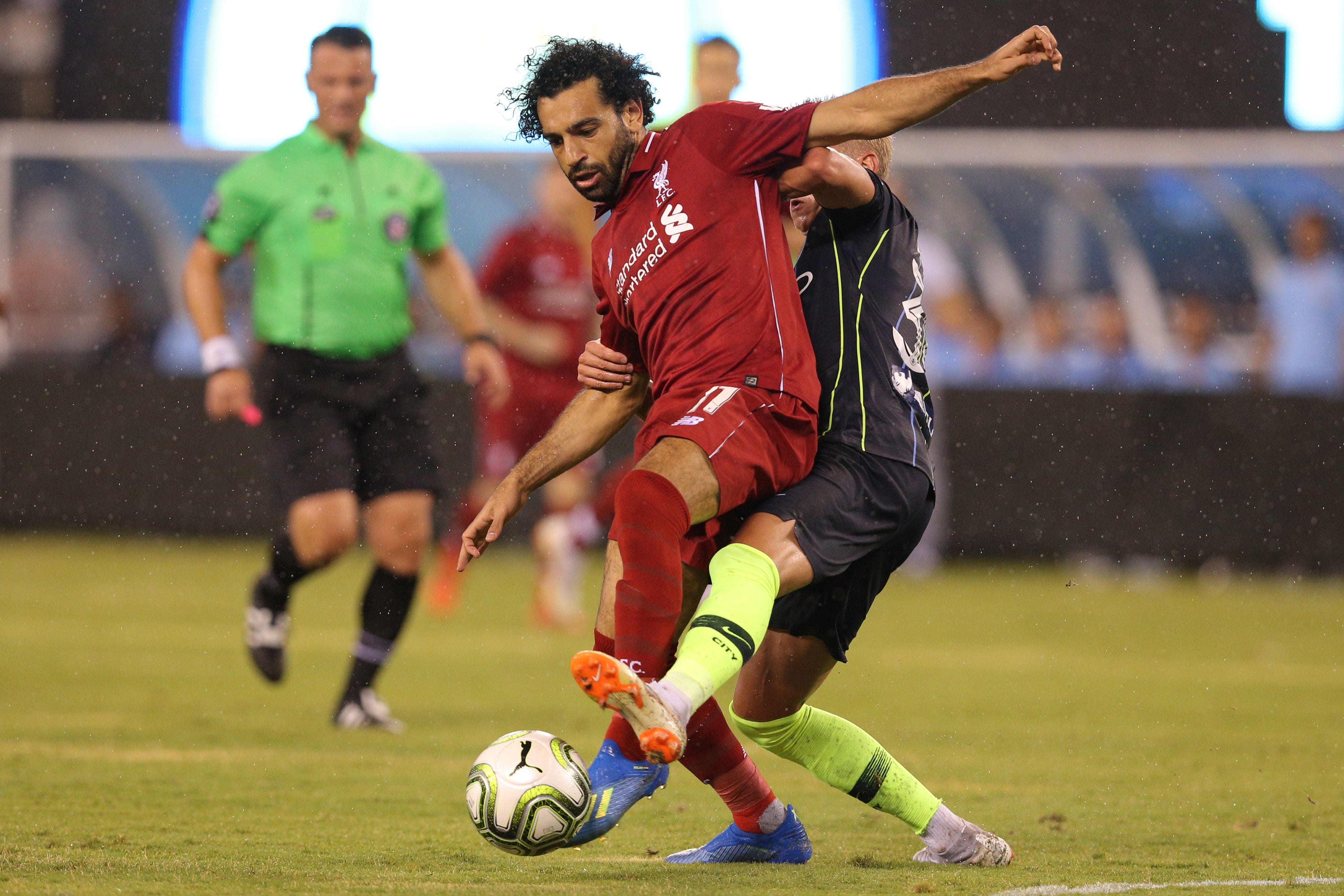 Liverpool forward Mohamed Salah plays the ball against Manchester City midfielder Oleksandr Zinchenko during the second half of an International Champions Cup soccer match at MetLife Stadium in East Rutherford, N.J.