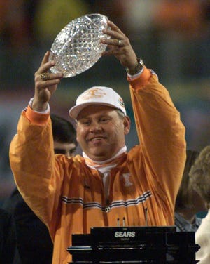Tennssee head coach Phil Fulmer holds up the national championship trophy after beating Florida State in the Fiesta Bowl on Jan. 4, 1999.