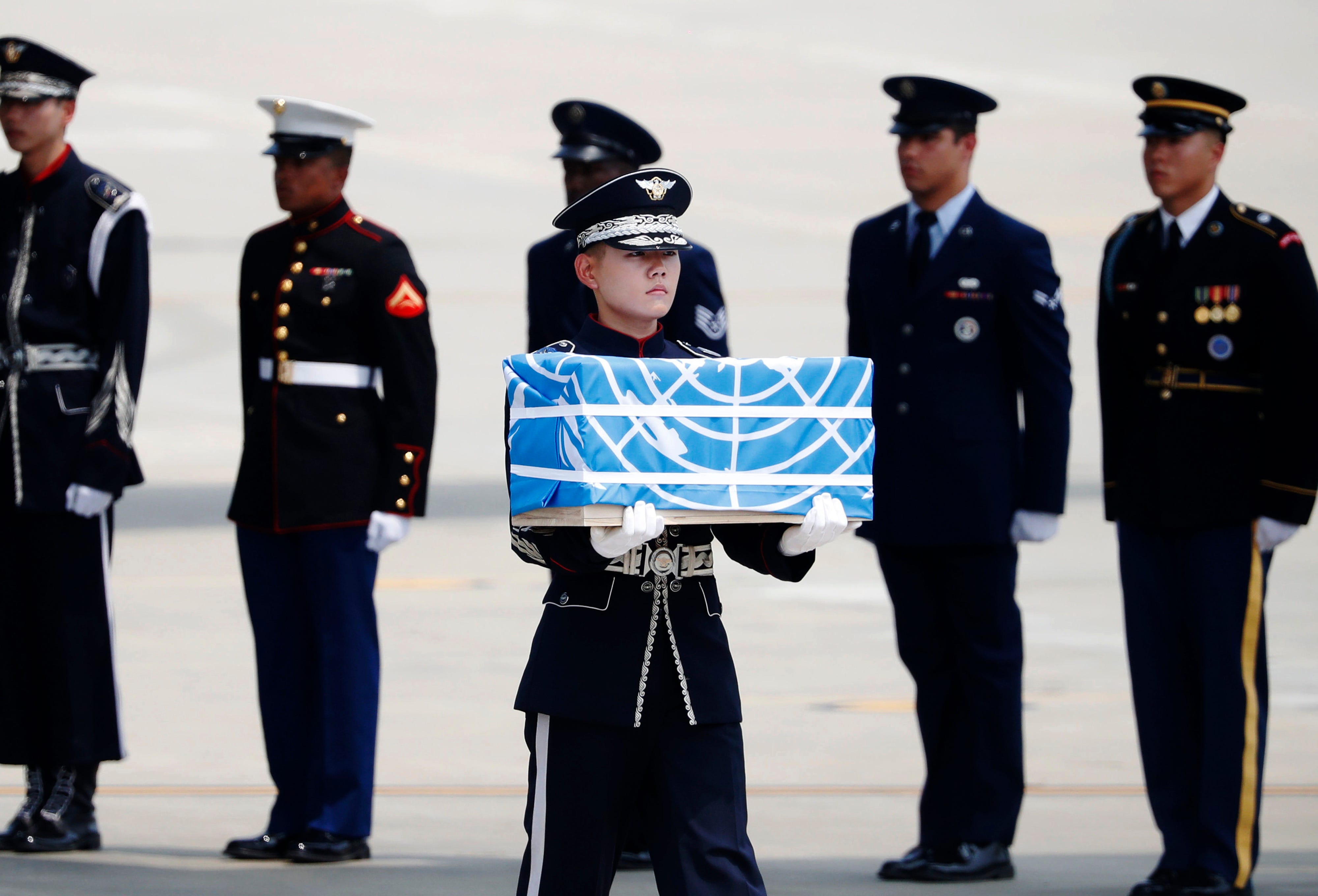 A soldier carries a casket containing a remain of a U.S. soldier who was killed in the Korean War during a ceremony at Osan Air Base in Pyeongtaek, South Korea, on July 27, 2018.  The U.N. Command said the 55 cases of war remains retrieved from North