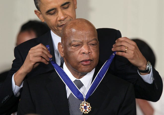 Rep. John Lewis (D-GA) is presented with the 2010 Medal of Freedom by President Barack Obama during an East Room event at the White House February 15, 2011 in Washington, DC. Obama presented the medal, the highest honor awarded to civilians, to twelve pioneers in sports, labor, politics and arts.