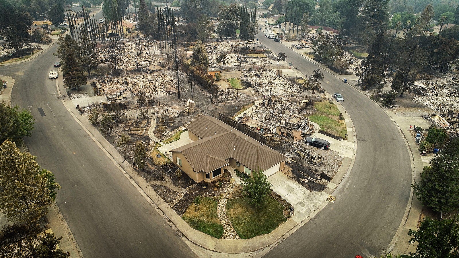 An aerial view of the homes of Harlan Drive and Bedrock Lane in the Lake Redding Estates neighborhood on July 31, 2018 shows the devastation caused by the Carr Fire which roared through the area late last week. The area remains closed to residents as