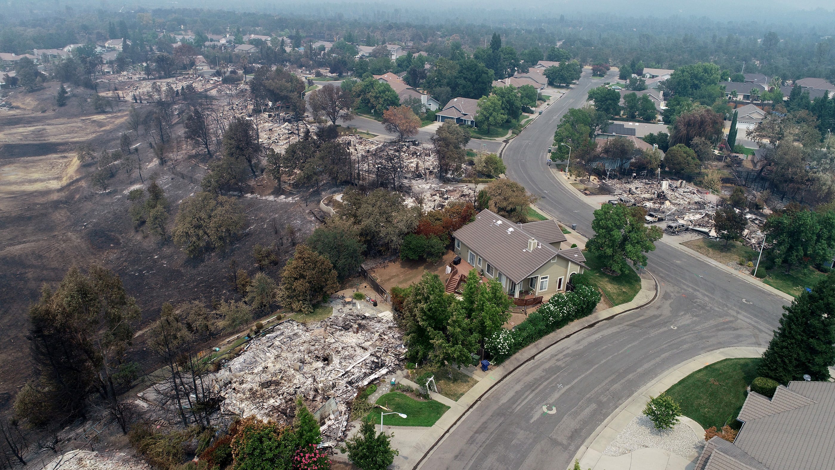 Homes in the River Ridge Park subdivision  in Redding, Calif. on Aug. 1, 2018, show damage from the Carr Fire.