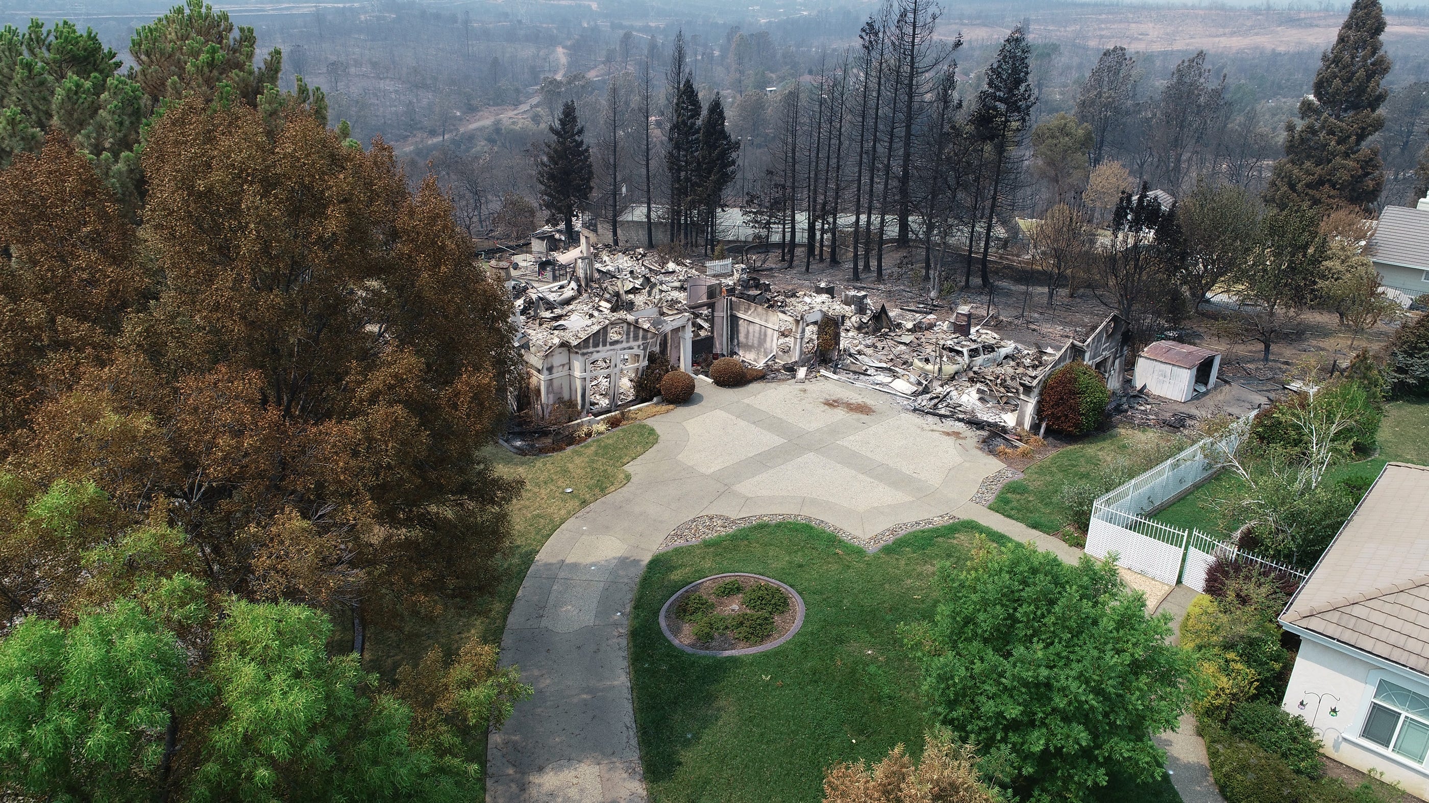 Homes in the River Ridge Park subdivision show the damage from the Carr Fire Aug. 1, 2018 in Redding, Calif. 