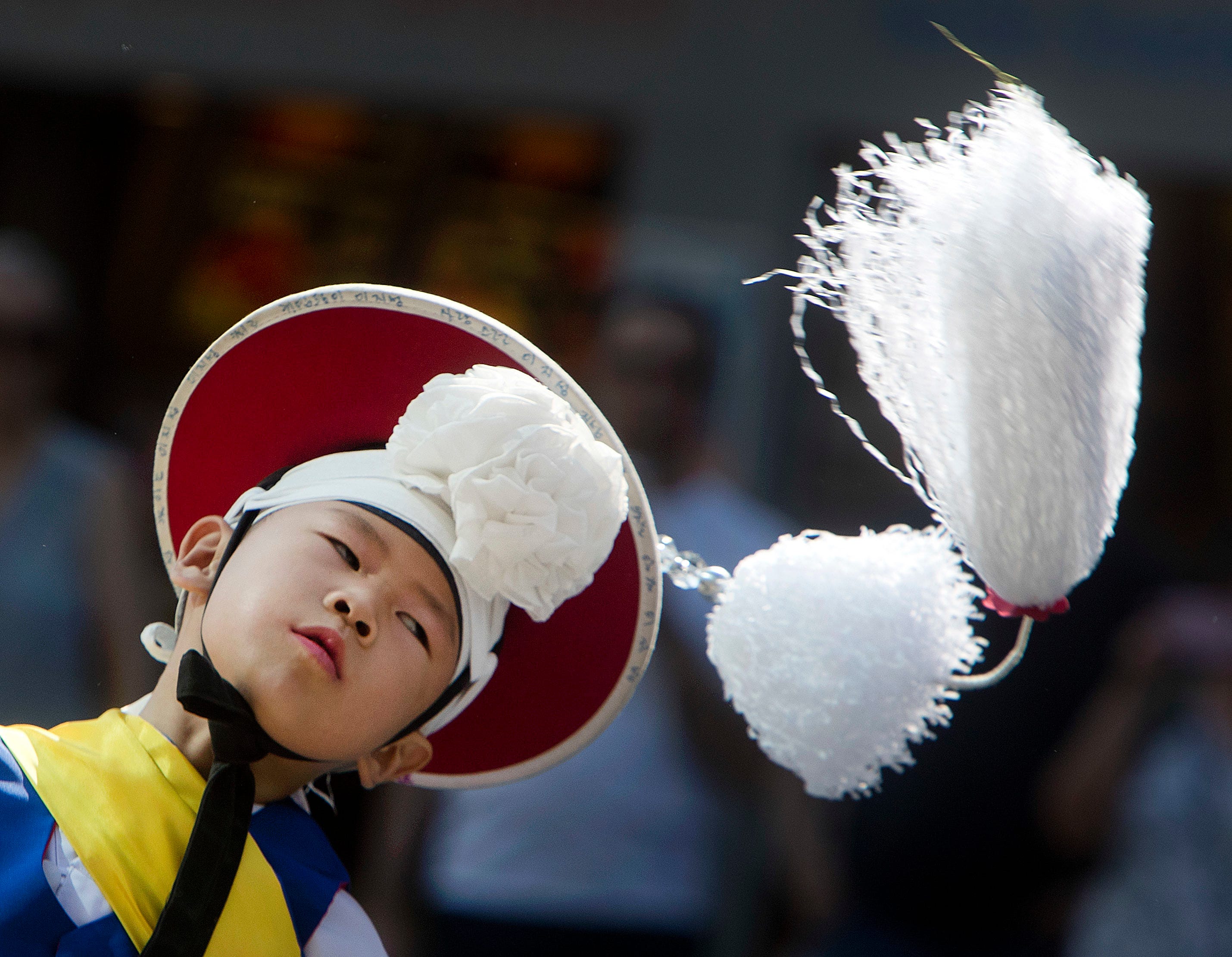 A little boy performs with a Korean dance and music group in downtown Frankfurt, Germany.