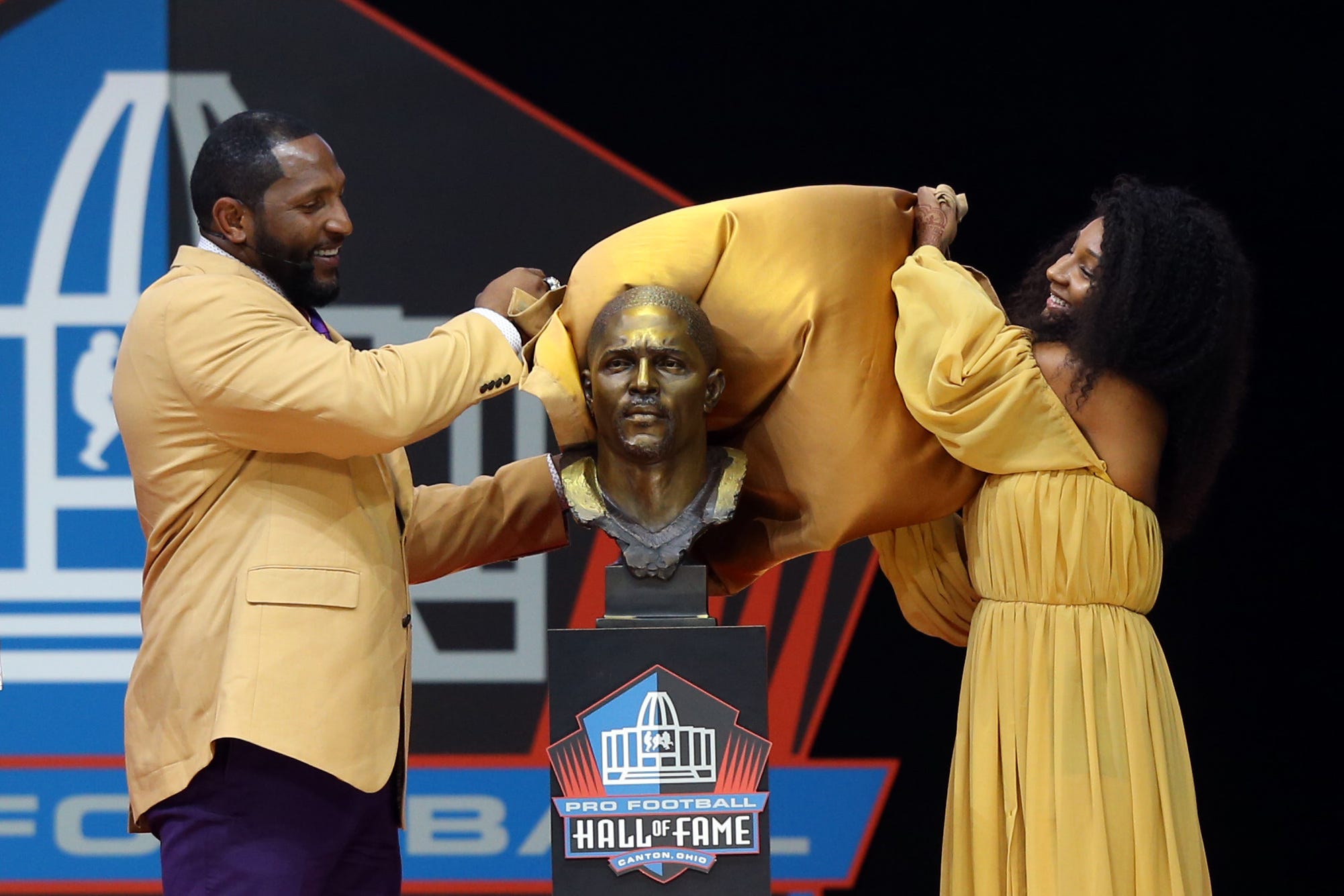 Pro Football Hall of Fame Class of 2018 enshrinee Ray Lewis stands with daughter Diaymon Lewis during the Pro Football Hall of Fame Enshrinement Ceremony at Tom Bensen Stadium.