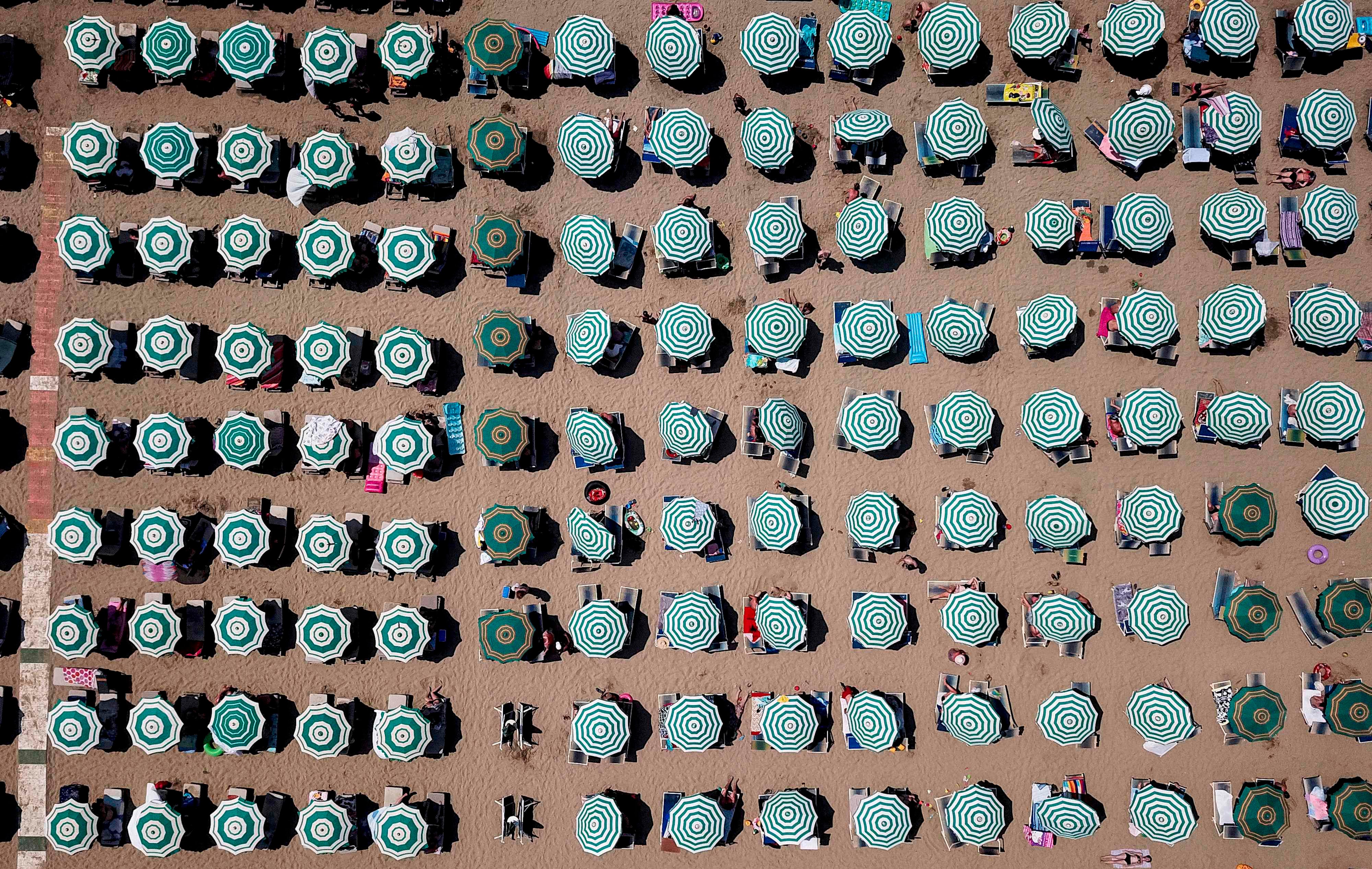 This aerial photograph shows parasols on a beach of the Adriatic Sea on Aug. 8, 2018 in Durres, Albania as a heatwave sweeps across Europe.