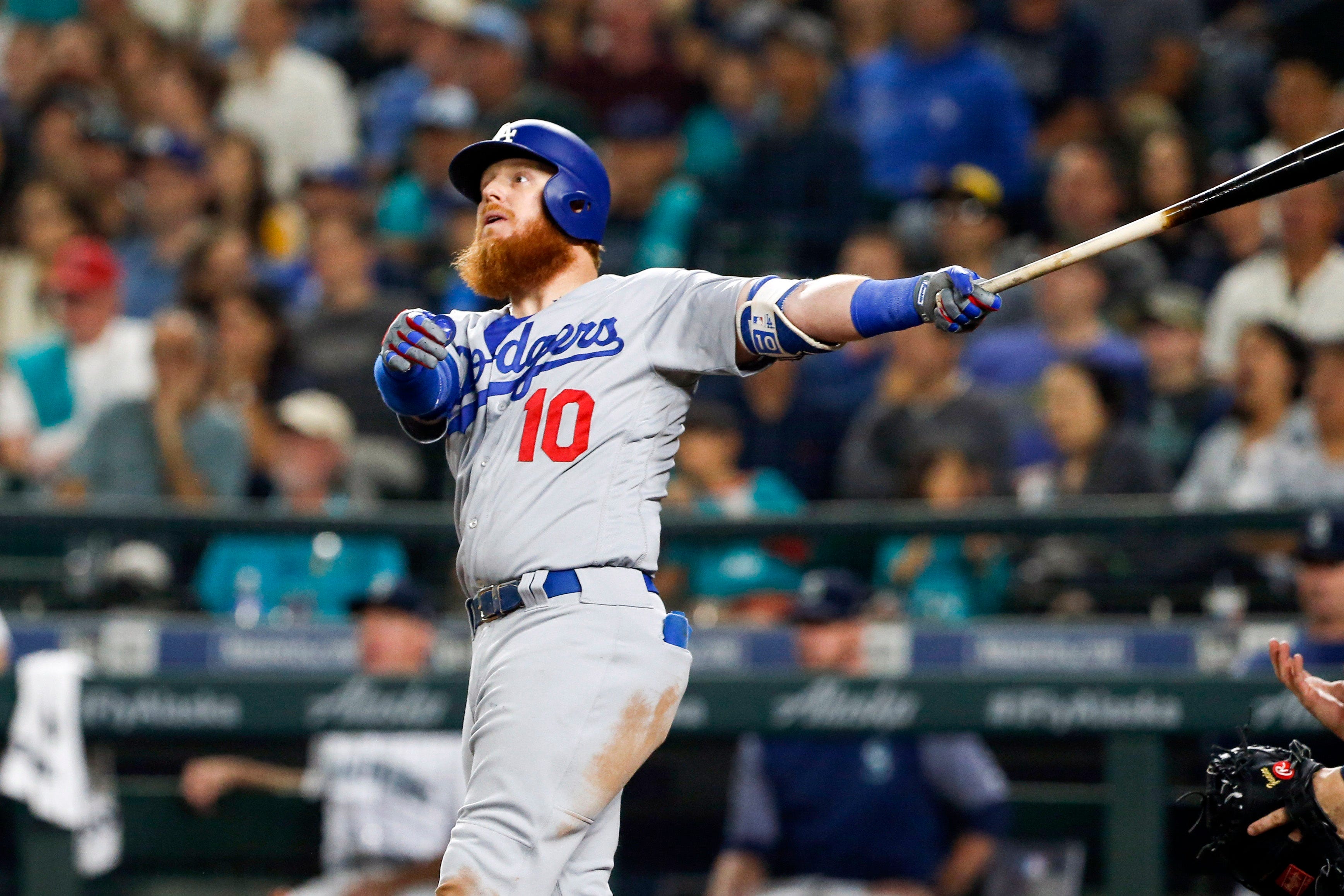 Dodgers slugger Justin Turner (10) watches his solo home run leave the yard during the eighth inning against the Mariners in Seattle.