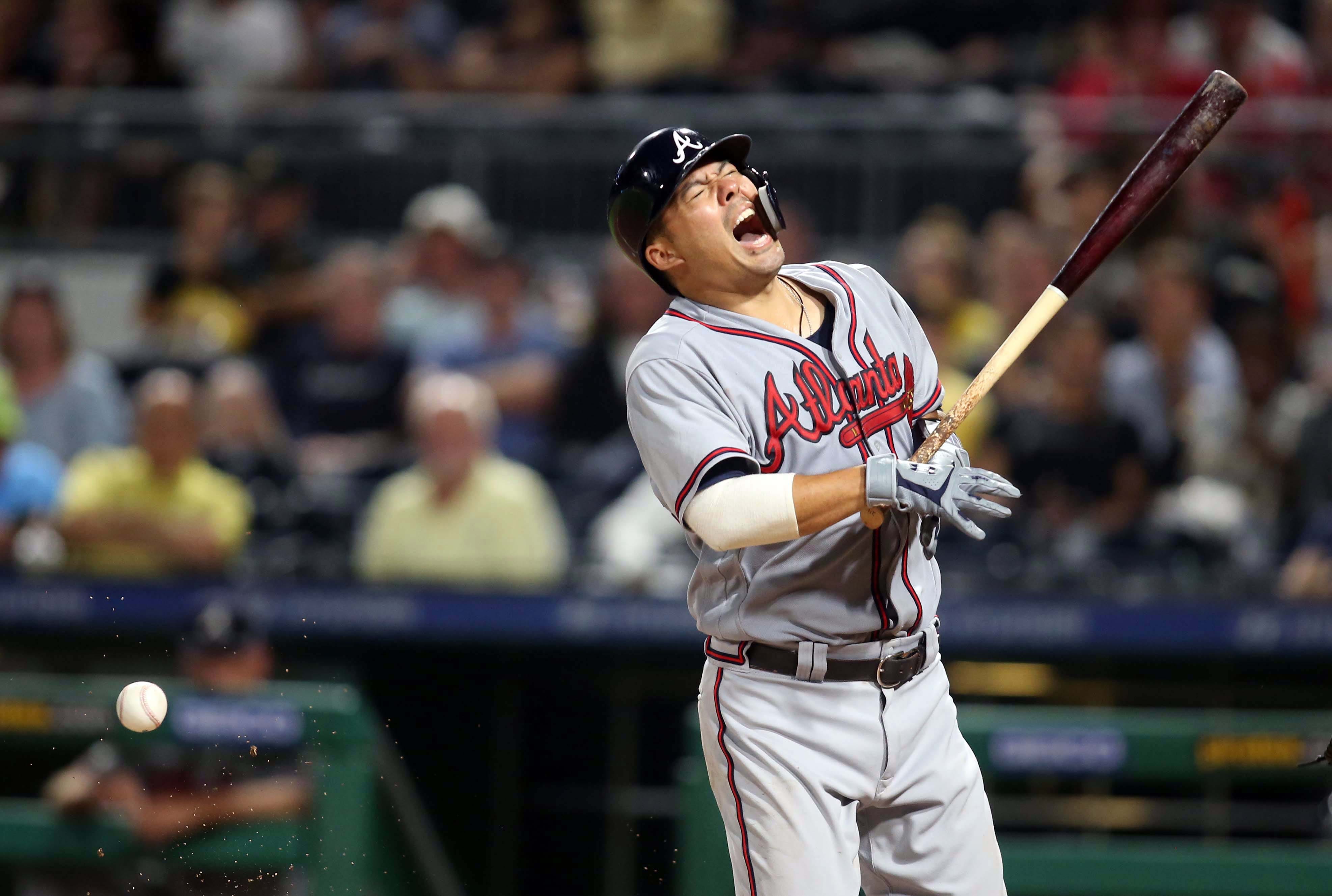 Atlanta Braves catcher Kurt Suzuki reacts after being hit by a pitch from the Pittsburgh Pirates during the ninth inning at PNC Park in Pittsburgh. The Braves won 6-1.