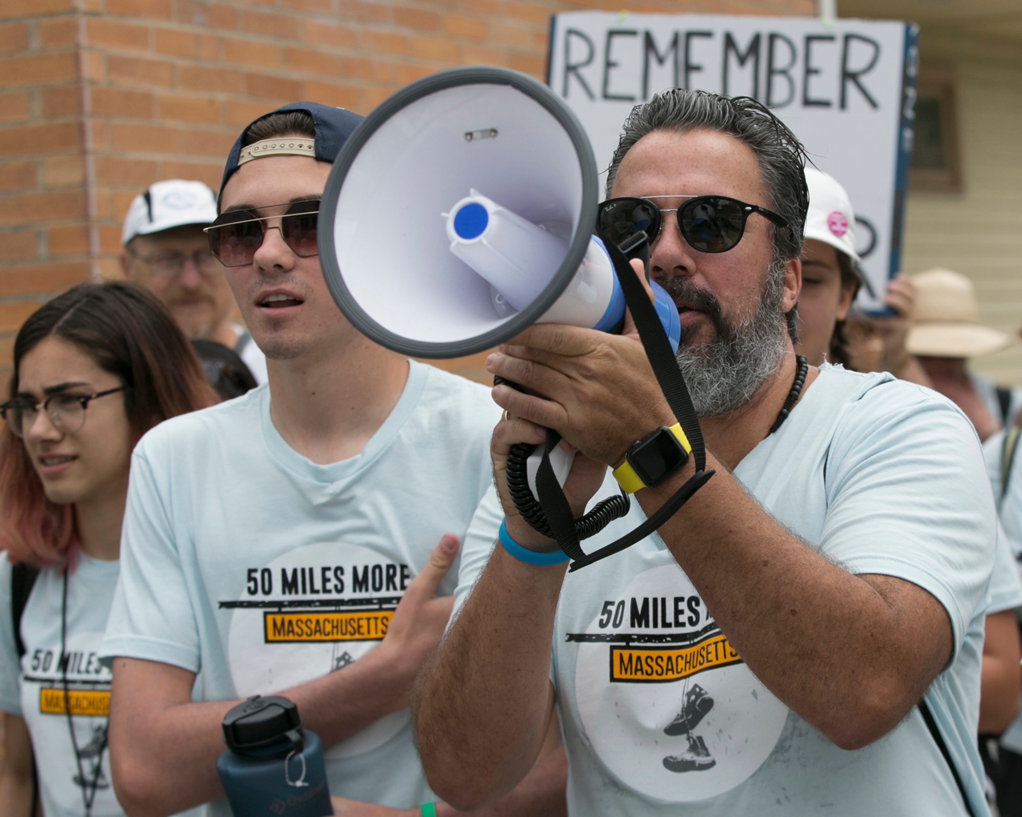 David Hogg (2-L), 18, a survivor of the Valentine's Day 2018 Parkland shooting and a resident of Parkland, Fla., is joined by Manuel Oliver (R), 50, father of murdered Parkland shooting victim Joaiquim Oliver, at a youth march to protest gun violence