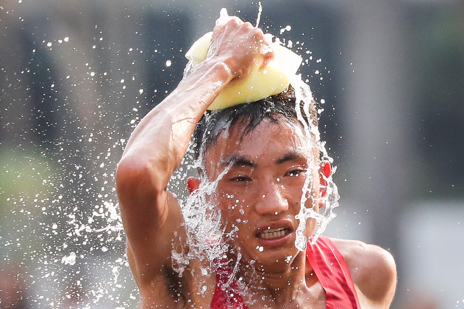 Duo Bujie of China cools off during the men's marathon at the 18th Asian Games in Jakarta, Indonesia.