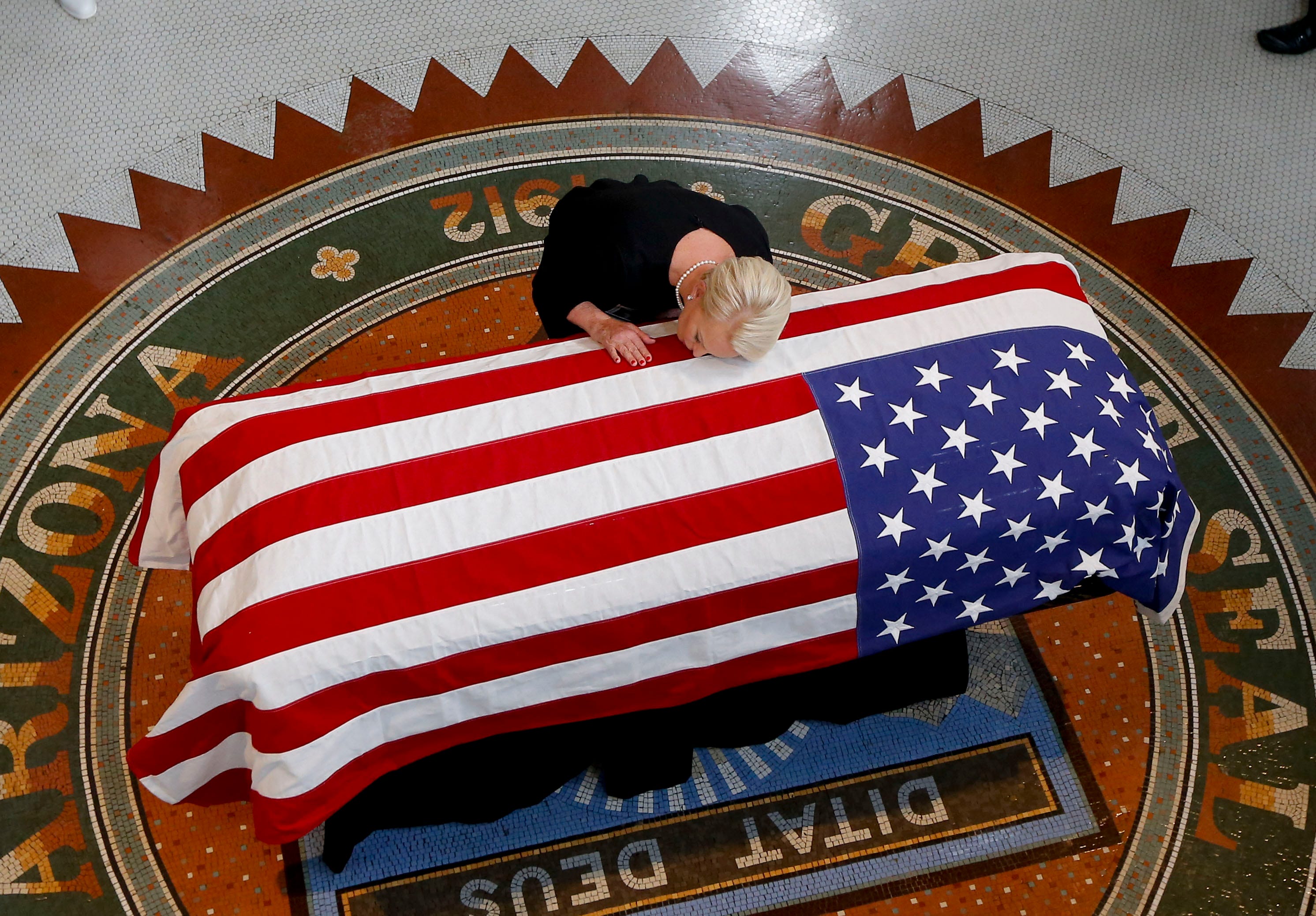 Cindy McCain, wife of Sen. John McCain (R-AZ) touches the casket during his memorial service at the Capitol on Aug. 29, 2018 in Phoenix, Ariz. Sen. McCain, a decorated war hero, died Aug. 25 at the age of 81 after a long battle with Glioblastoma, a f