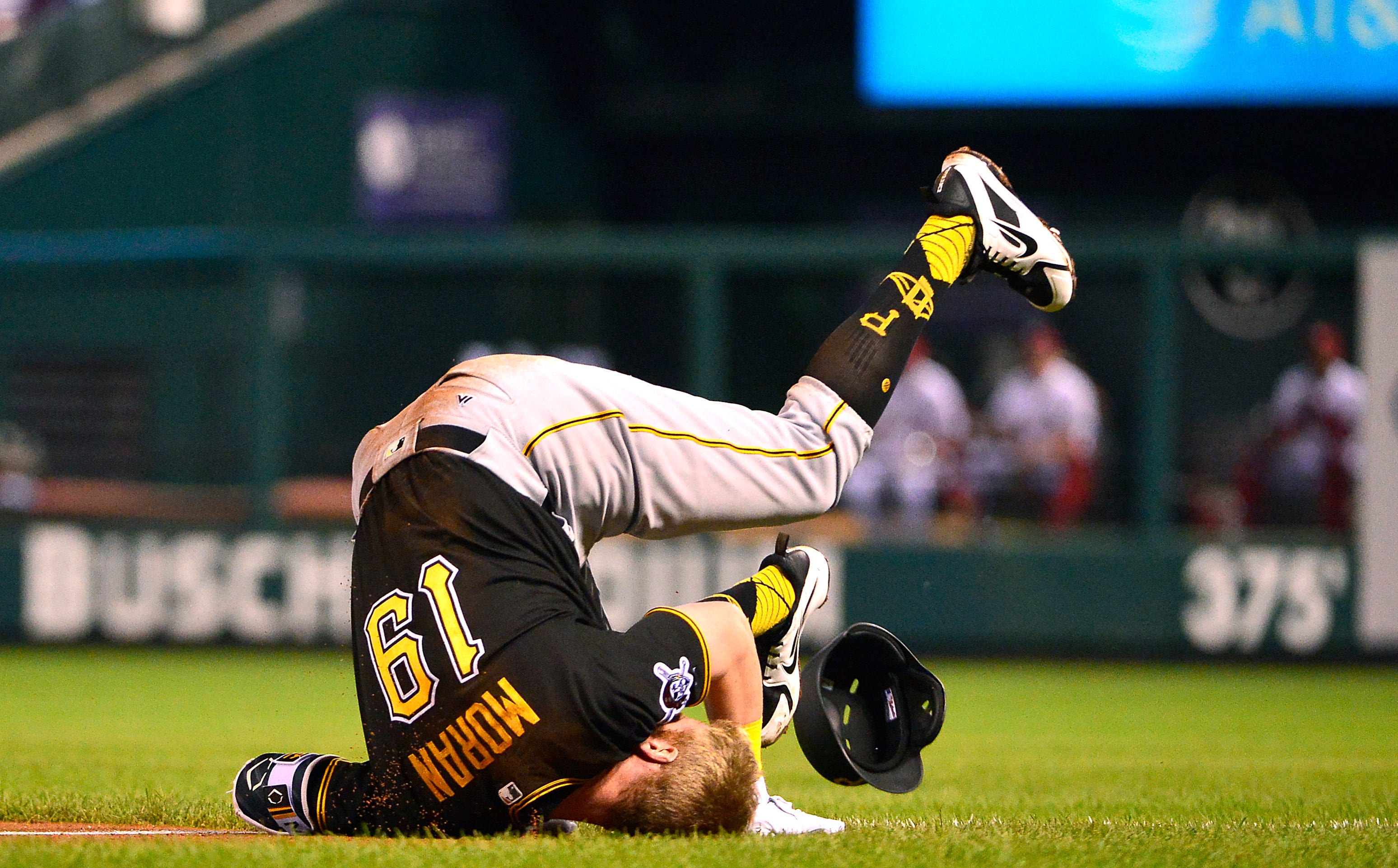 Pittsburgh Pirates third baseman Colin Moran falls to the grass after being forced out at first base during the fourth inning against the St. Louis Cardinals at Busch Stadium in St. Louis.