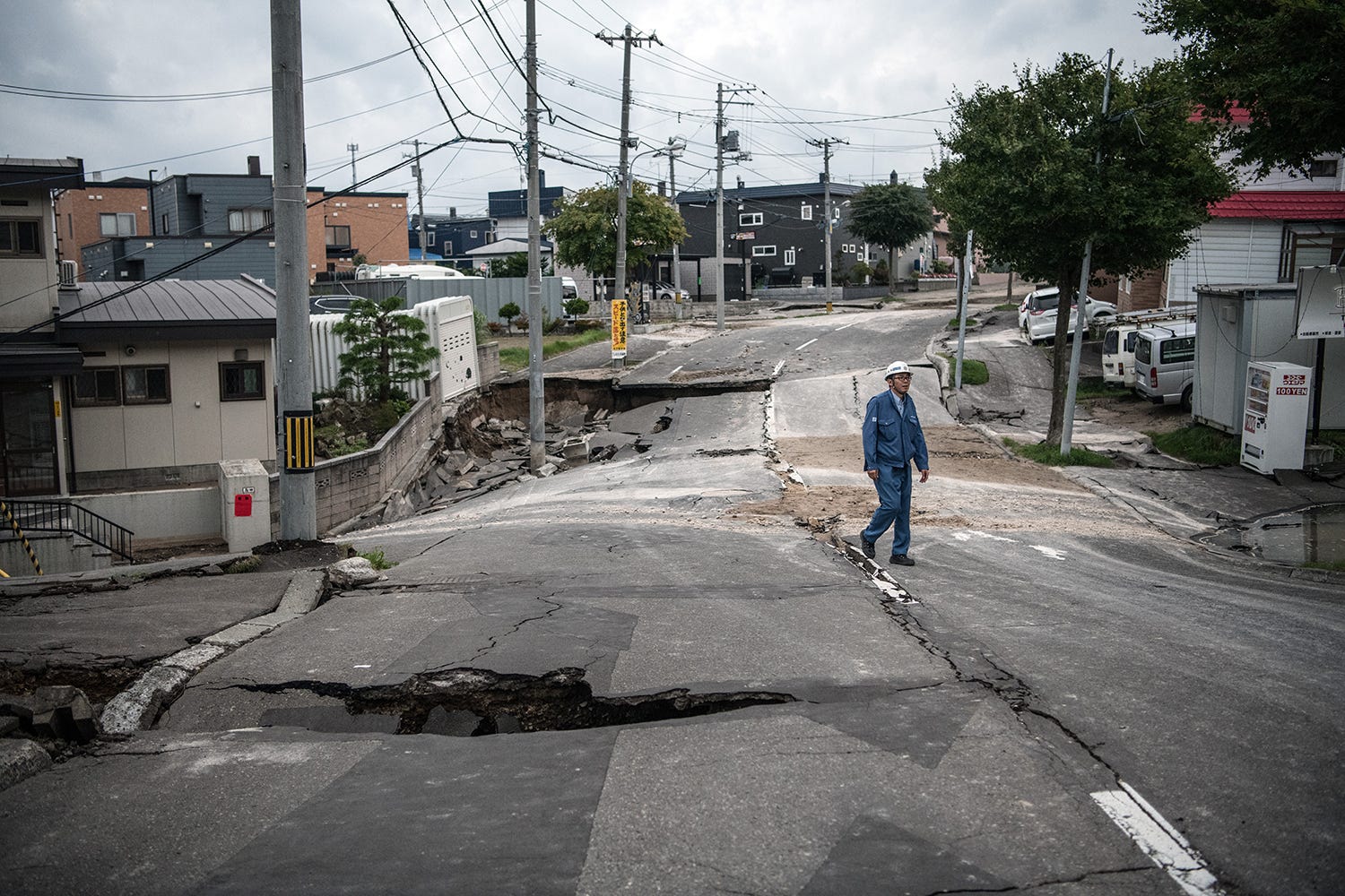 A man walks on a road that was heavily damaged by an earthquake in Kiyota, Japan. Sixteen people are now known to have been killed with many still missing and hundreds injured after a powerful 6.7-magnitude earthquake struck the northern Japanese isl