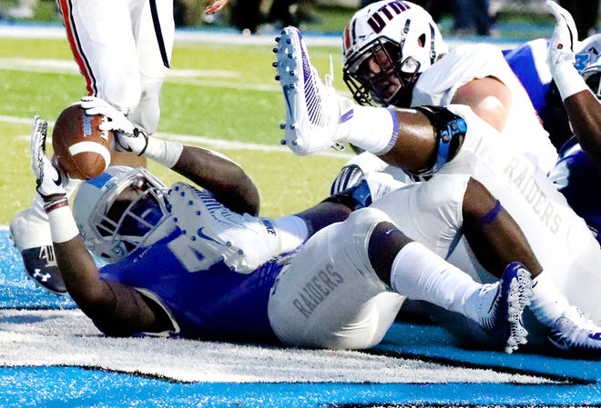 MTSU's Chaton Mobley (44) holds up the football after scoring a touchdown against UT Martin in the first half Saturday.