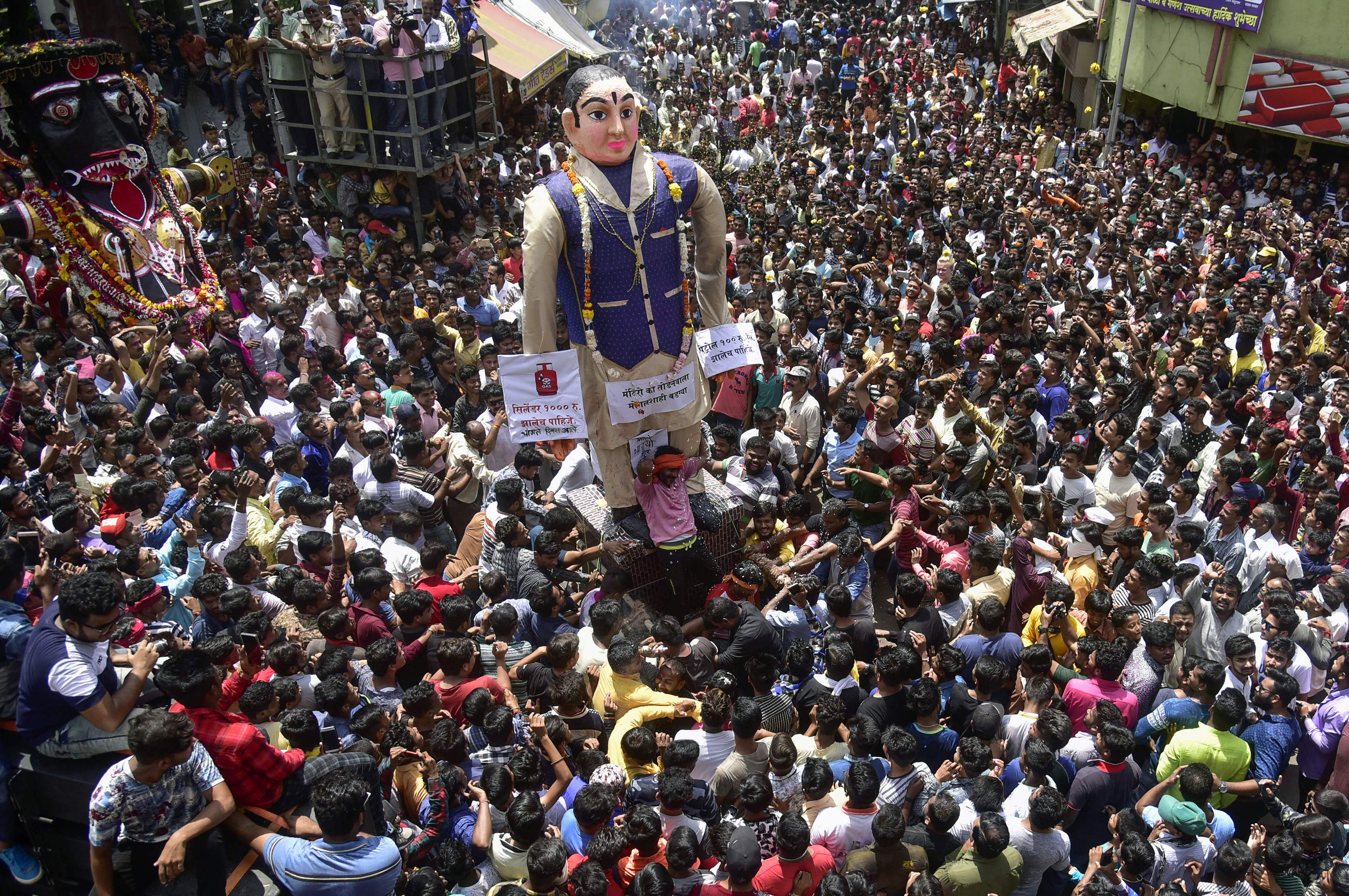 Indian revelers gather around idols as they are paraded to celebrate the Marbat Festival in Nagpur on Sept. 10, 2018. The festival, which is unique to the central Indian city, involves the construction, parading and burning of idols meant to represen