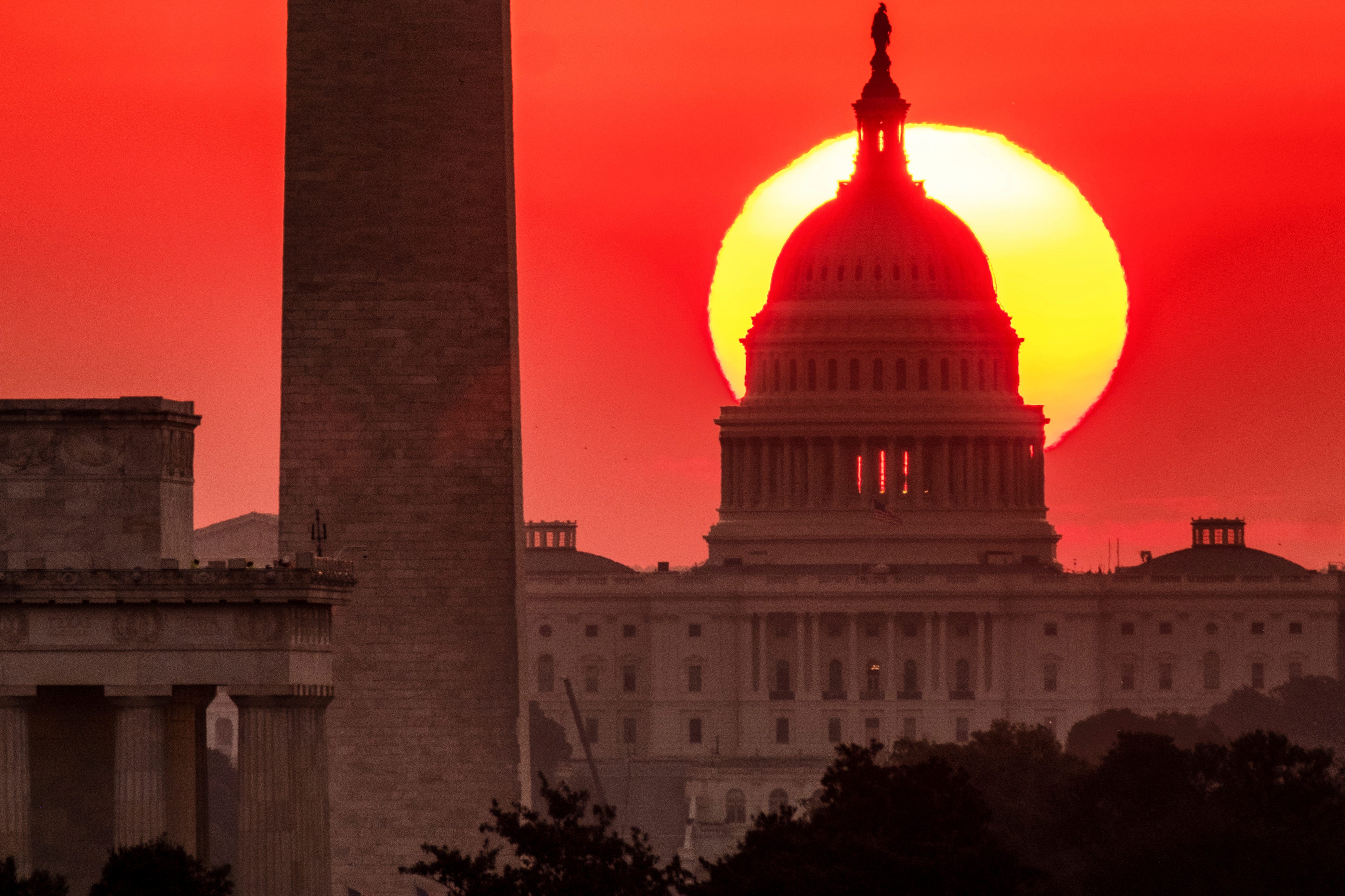 The sun rises behind the U.S. Capitol in Washington.