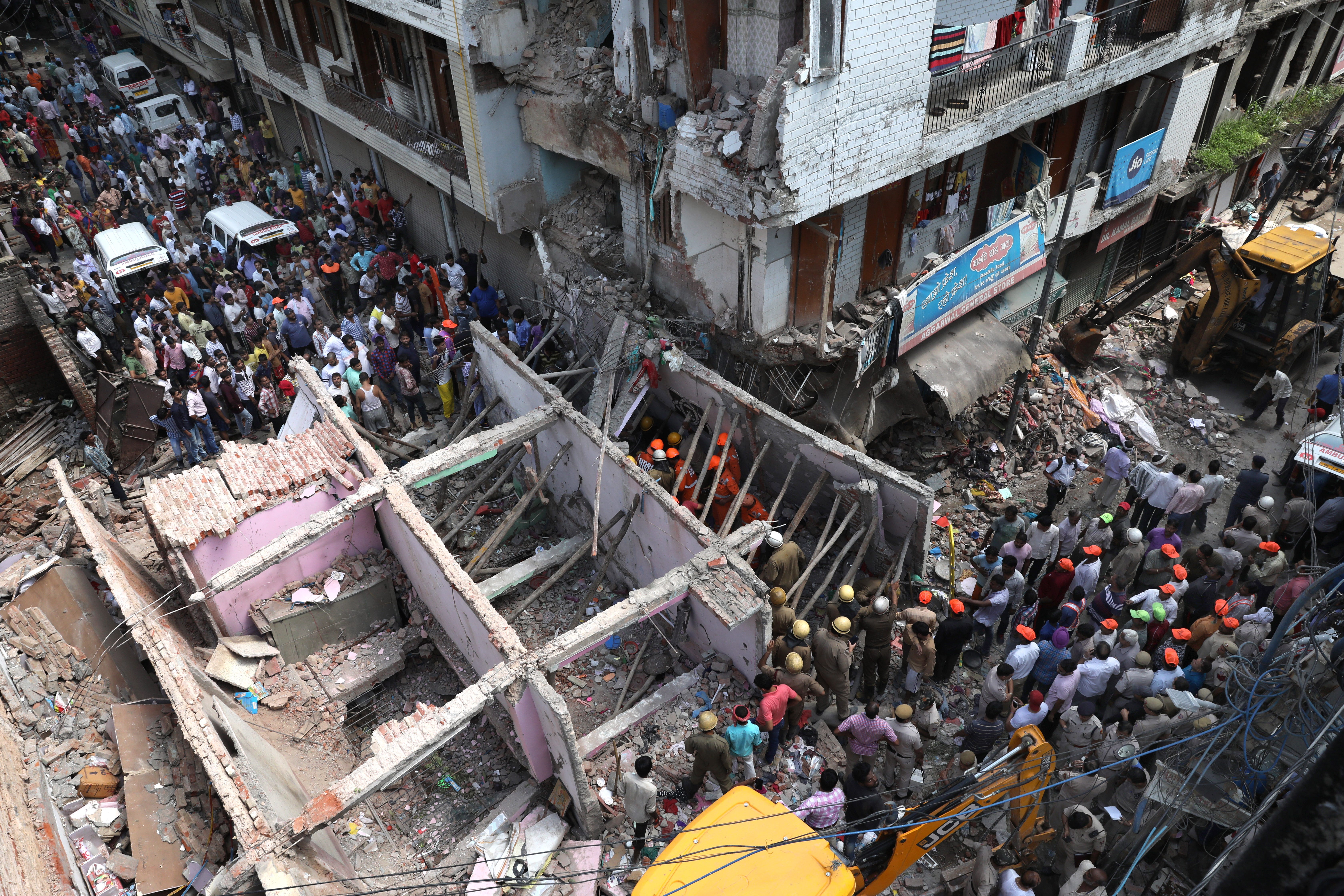 Indian National Disaster Response Force (NDRF) rescue workers operate on the site of a building collapse in New Delhi, India on Sept. 26, 2018. According to media reports, at least five people were killed and many injured in a building collapse in Ne