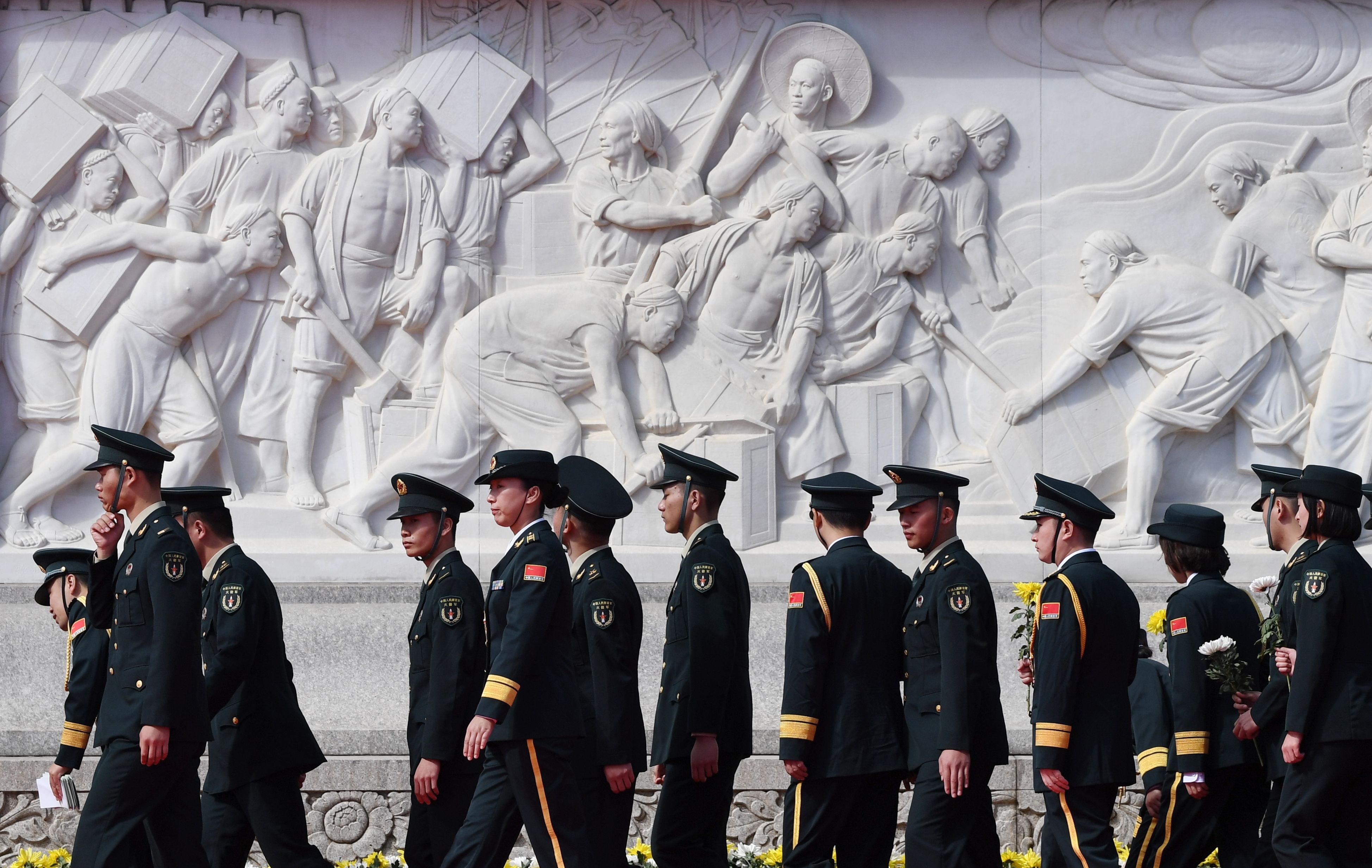 Chinese soldiers walk past the Monument to the People's Heroes during a ceremony in Beijing's Tiananmen Square, on the eve of National Day on Sept. 30, 2018. China marks its National Day, the 69th anniversary of the founding of the People's Republic 