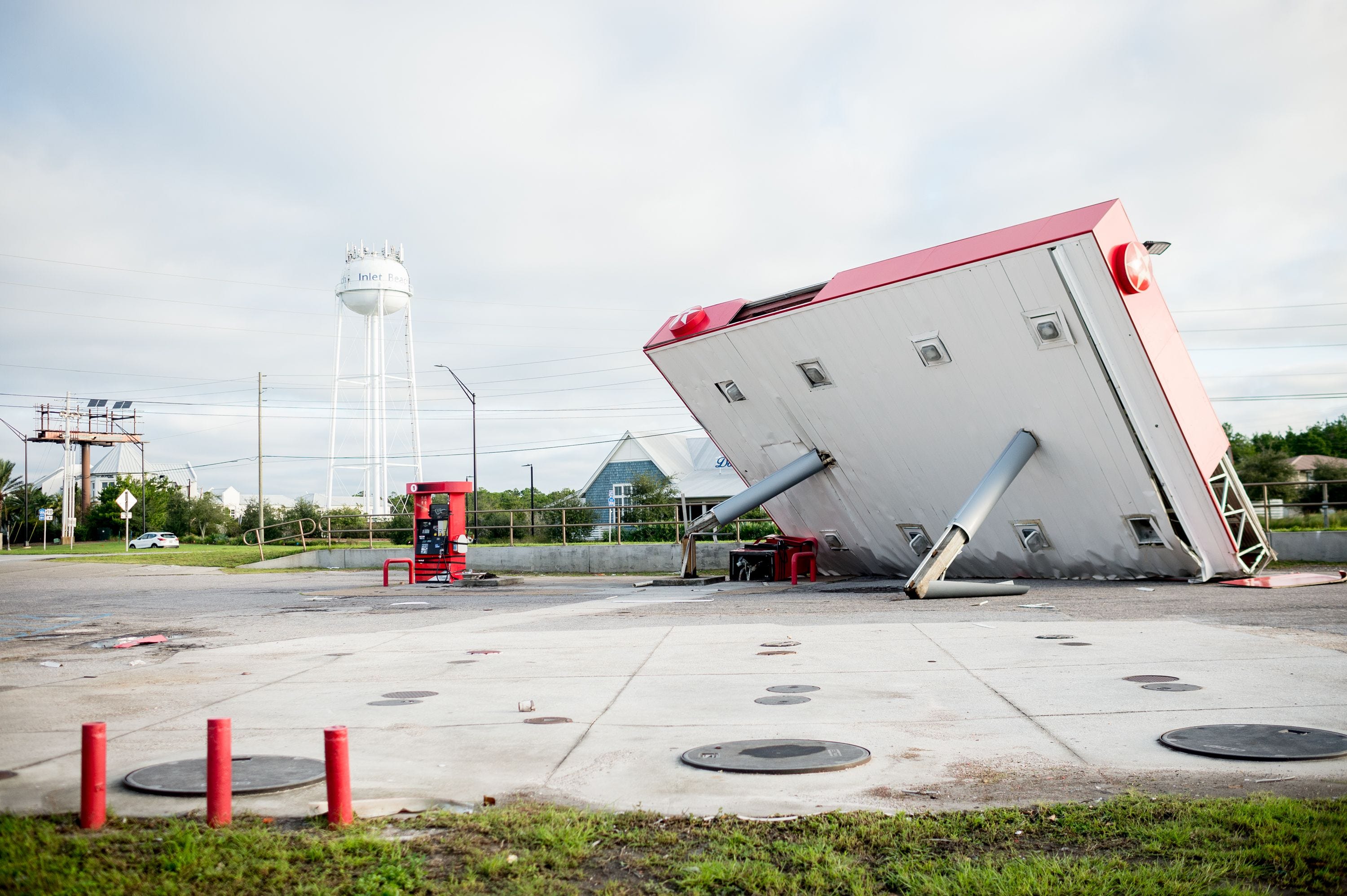 The overhang of a gas station is toppled over in the aftermath of Hurricane Michael on October 11, 2018 in  Inlet Beach, Florida. - Residents of the Florida Panhandle woke to scenes of devastation Thursday after Michael tore a path through the coastal region as a powerful hurricane that killed at least two people. (Photo by Emily KASK / AFP)EMILY KASK/AFP/Getty Images ORG XMIT: Hurricane ORIG FILE ID: AFP_19Y1MK