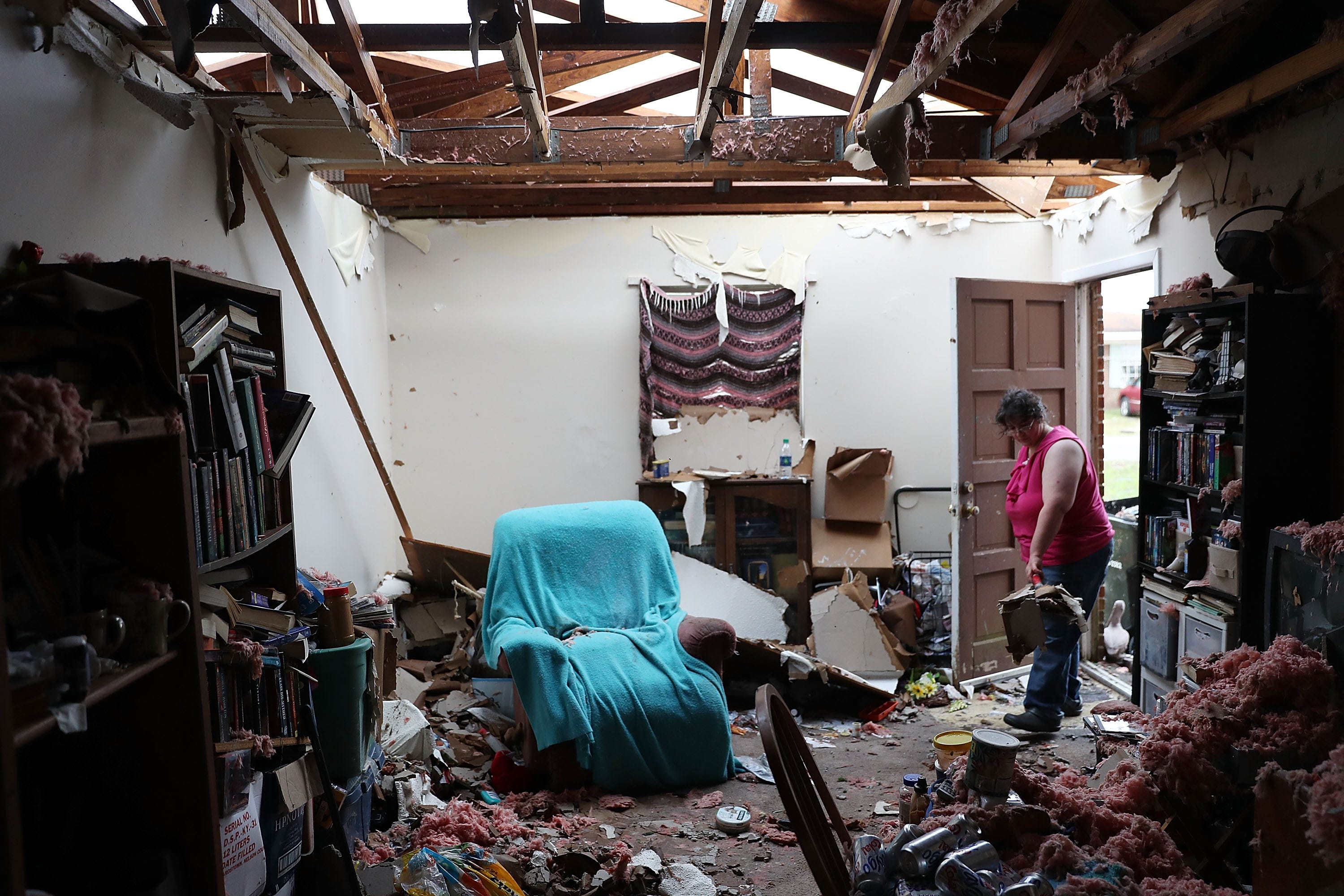 PANAMA CITY, FL - OCTOBER 11:  Amanda Logsdon begins the process of trying to clean up her home after the roof was blown off by the passing winds of hurricane Michael on October 11, 2018 in Panama City, Florida. The hurricane hit the Florida Panhandle as a category 4 storm.  (Photo by Joe Raedle/Getty Images) ORG XMIT: 775241167 ORIG FILE ID: 1051882830