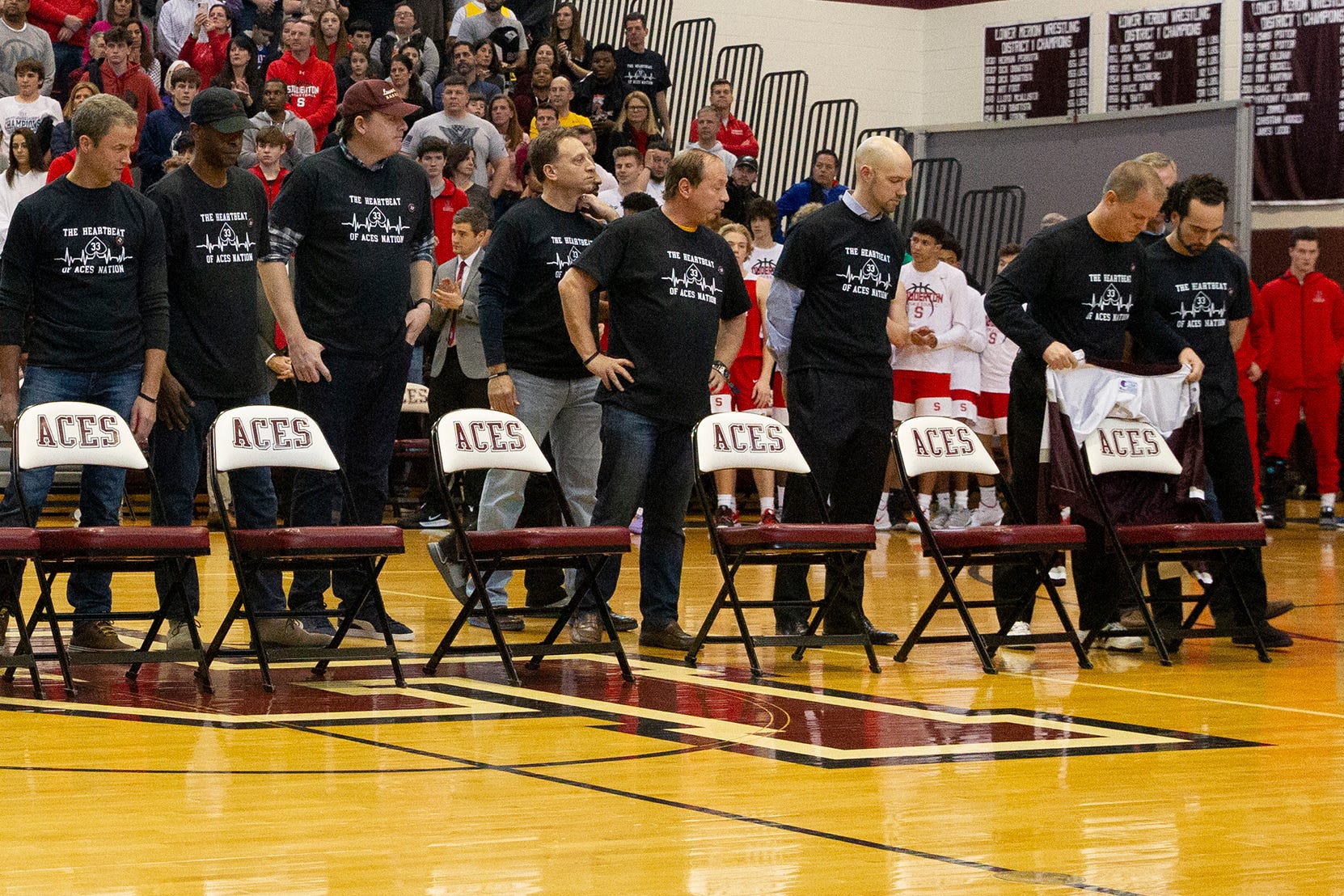 Lower Merion High basketball alumni place nine empty chairs on the court to symbolize the nine victims of the helicopter crash that included Kobe Bryant.