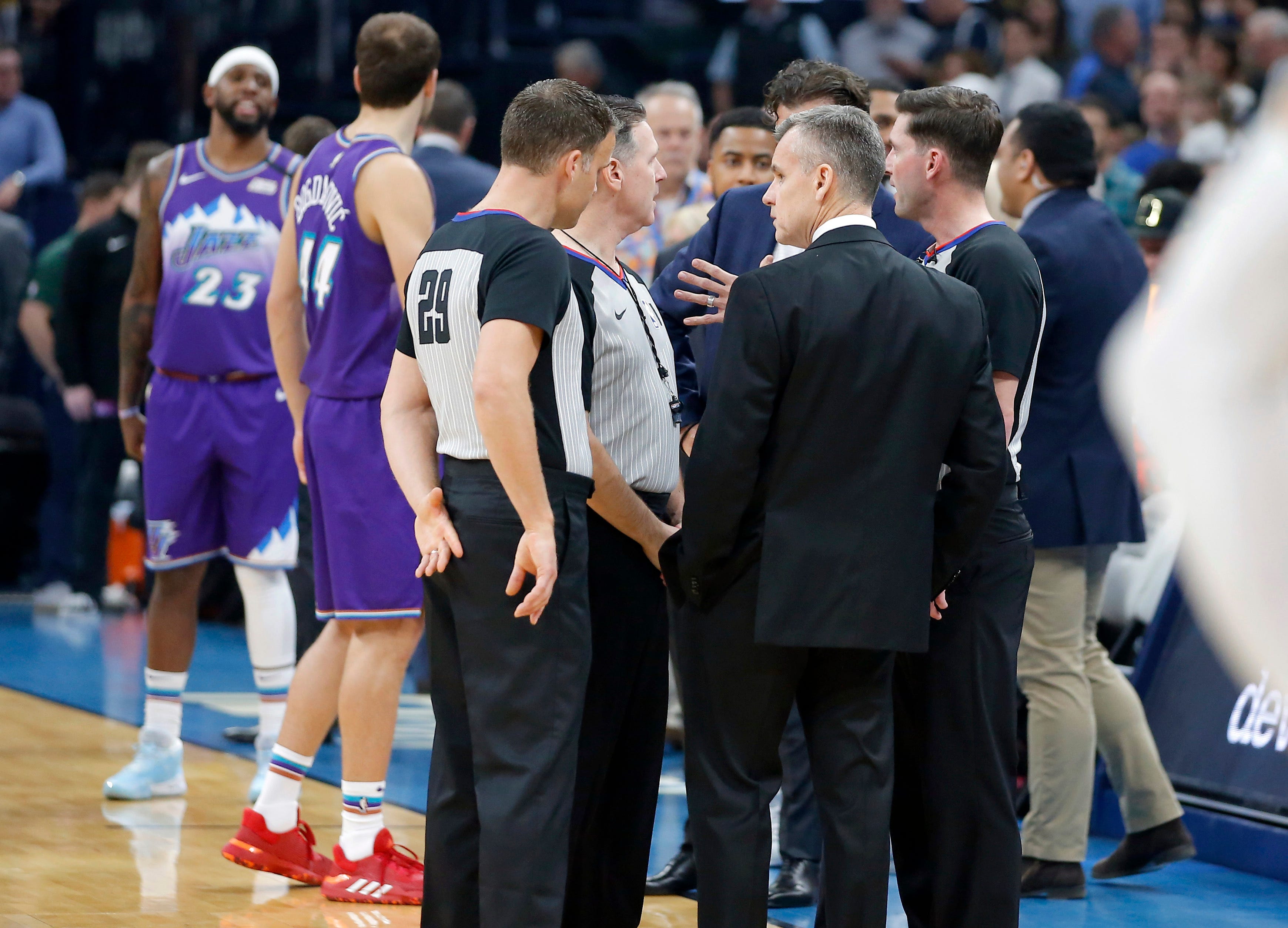 Then-Oklahoma City coach Billy Donovan meets with officials before the Thunder-Jazz game was postponed.