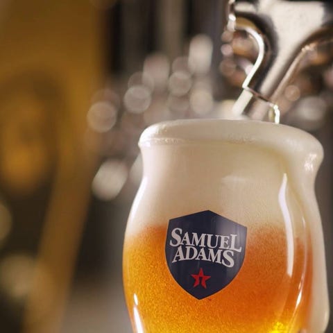 Beer being poured into a Samuel Adams glass