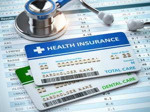 Health insurance cards and a stethoscope on test results