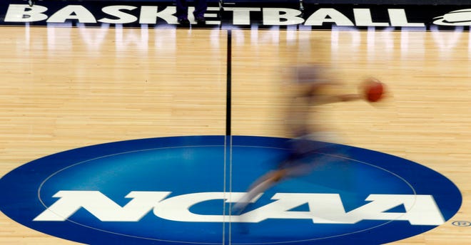 FILE - In this March 14, 2012, file photo, a player runs across the NCAA logo during practice in Pittsburgh before an NCAA tournament college basketball game. A court decision the NCAA says will hurt college sports by allowing student-athletes to be paid "vast sums" of money will go into effect. That's after the Supreme Court declined Tuesday to intervene at this point. Justice Elena Kagan denied the NCAA's request to put a lower court ruling on hold at least temporarily while the NCAA asks the Supreme Court to take up the case.  (AP Photo/Keith Srakocic, File)
