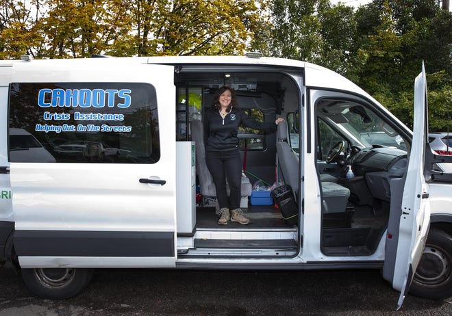 CAHOOTS clinical coordinator Kate Gillespie stands in one of the vans used to respond to calls in Eugene.