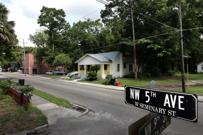 A street sign marks Northwest 5th Avenue in a neighborhood where a planned student housing complex has generated protests. [Gainesville Sun, File]