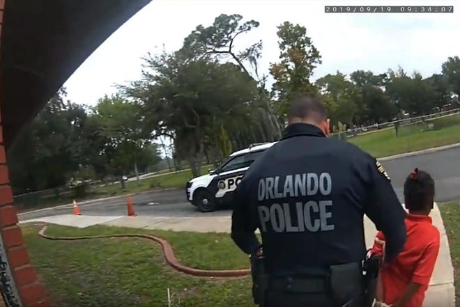 Orlando Police Officer Dennis Turner leads 6-year-old Kaia Rolle away Sept. 19, 2019, after her arrest on a charge of kicking and punching staff members at the Lucious & Emma Nixon Academy Charter School in Orlando. Turner was fired shortly after the arrest for not getting the approval of a watch commander to arrest someone younger than 12.