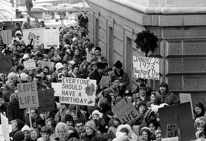 An estimated 5,000 people, women and men, march around the Minnesota Capitol building protesting the U.S. Supreme Court&#x2019;s Roe v. Wade decision, ruling against state laws that criminalize abortion, in St. Paul, Minn., Jan. 22, 1973. The marchers formed a &#x201c;ring of life&#x201d; around the building.