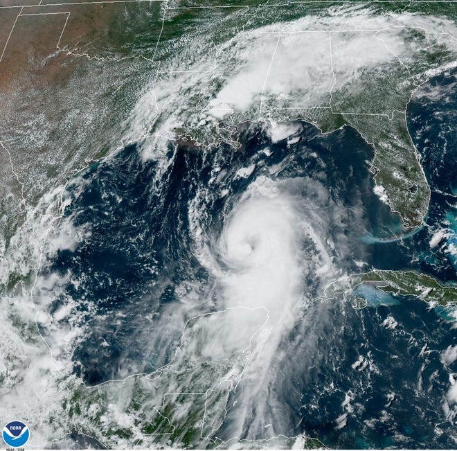 In this August 25, 2020 NOAA satellite photo, Hurricane Laura strengthens in the Gulf of Mexico while Marco drenches parts of the Southeast. (NOAA handout)