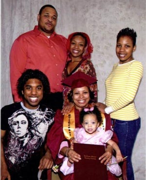 Melinda Pointer's family poses with her after her graduation from Northcoast Medical Training Academy. Pictured from left to right, top: Justin Walker, Princess Pointer, Ceanne Wright; bottom: Alex Davis, Melinda Pointer, Alexandria Jones.