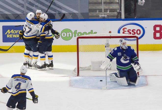 Vancouver Canucks goaltender Jacob Markstrom (25) pauses after giving up a goal as St. Louis Blues' Ryan O'Reilly (90), David Perron (57) and Jaden Schwartz (17) celebrate during Game 4 of a first-round playoff series Aug. 17, 2020, in Edmonton, Alberta.