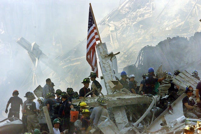 In this Sept. 13, 2001 file photo, an American flag flies over the rubble of the collapsed World Trade Center buildings in New York.